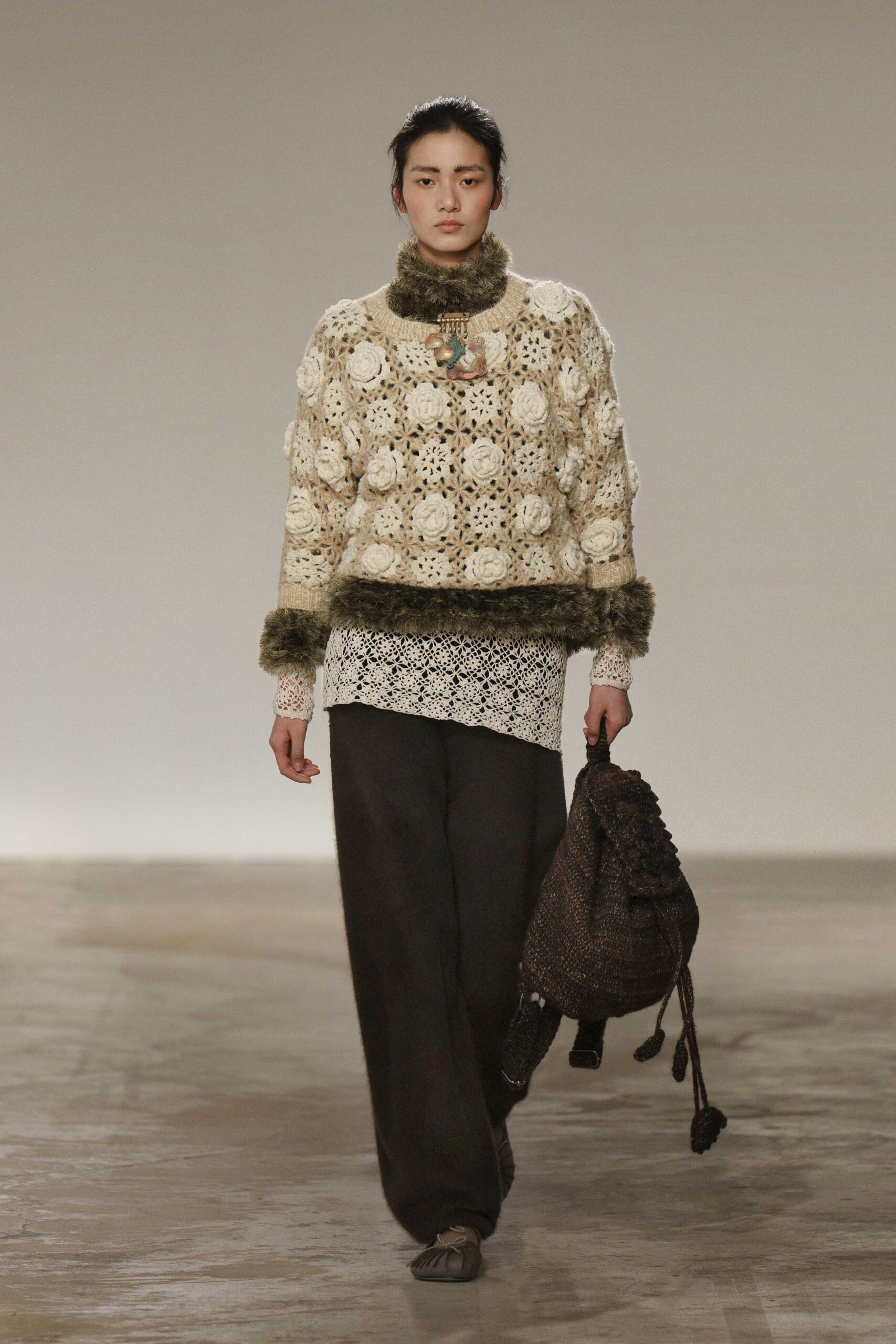beige crochet sweater with black pants