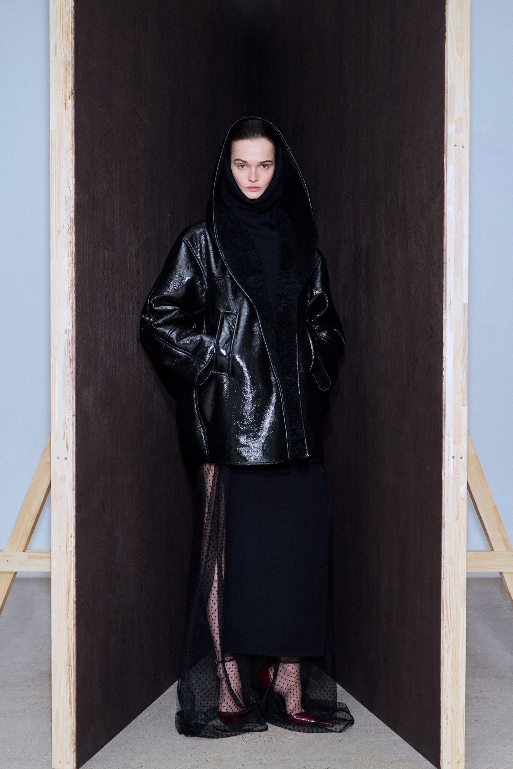 black leather long-sleeve collared oversized pockets coat