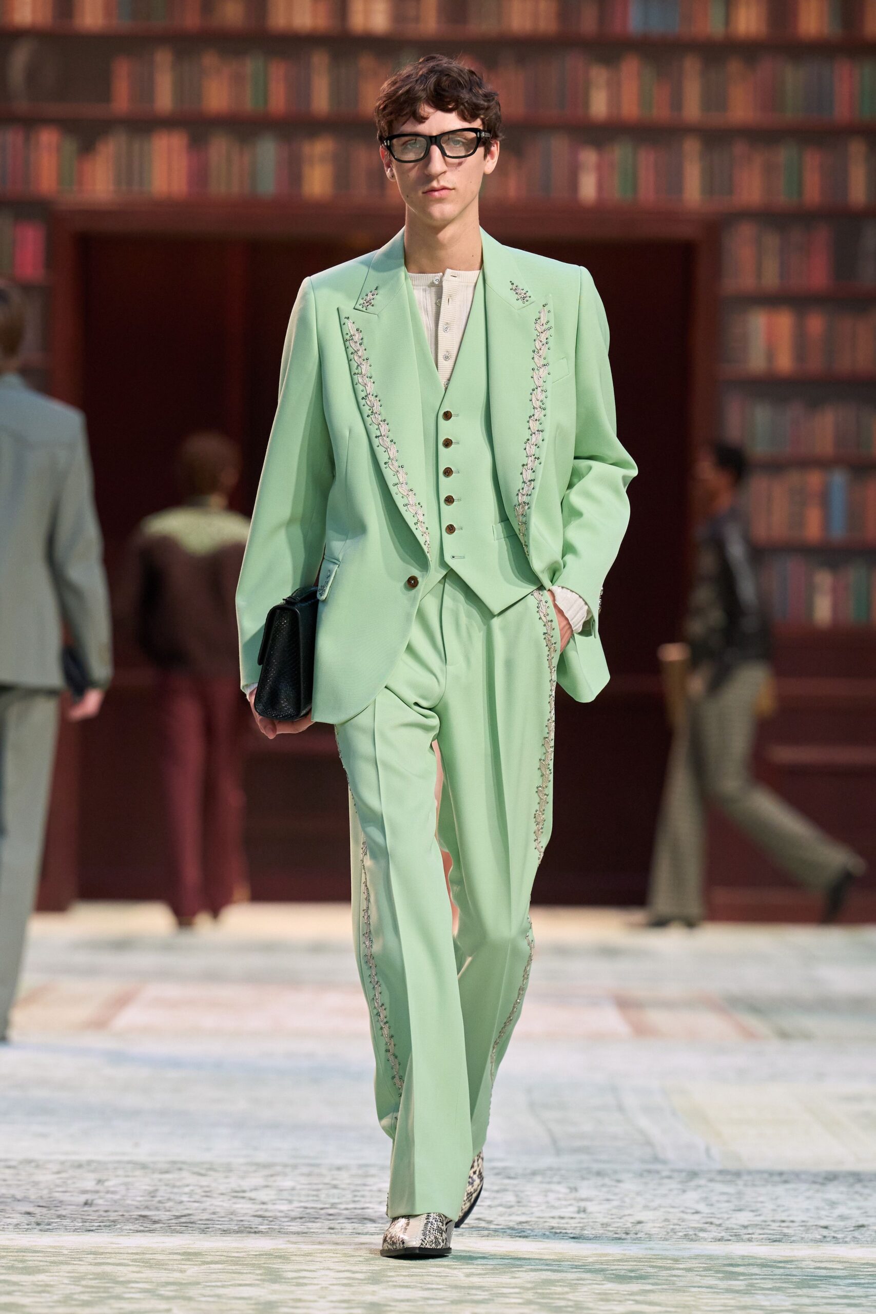 green tailored suit with beige shirt