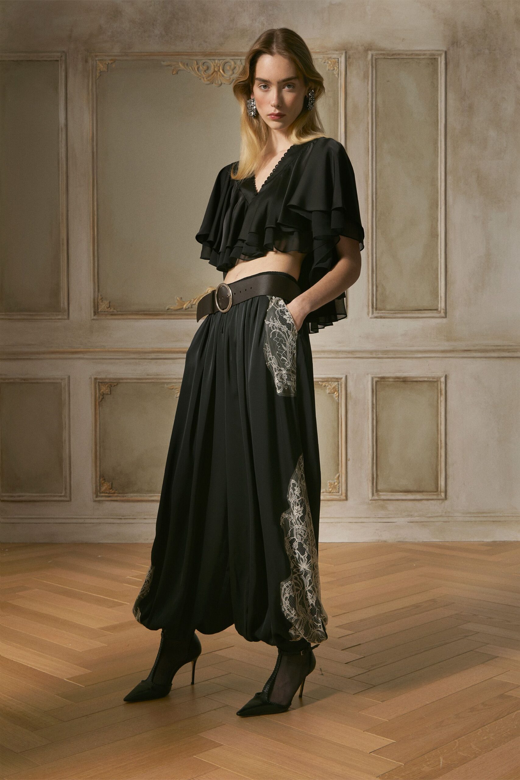 black ruffled top and relaxed pants