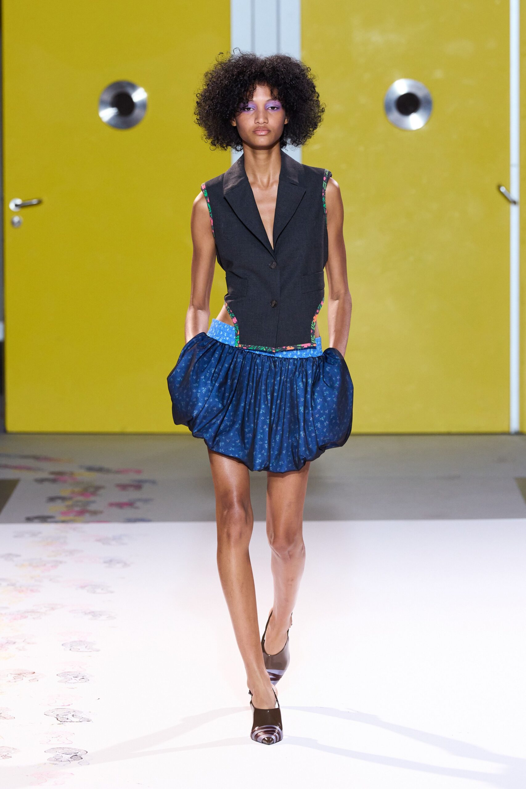 black vest blue pleated skirt