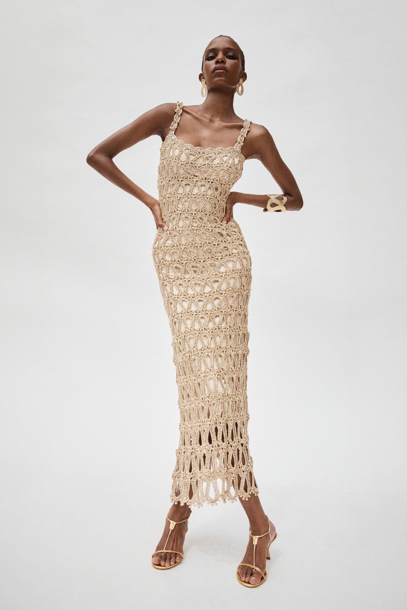 beige crochet midi dress with gold shoes