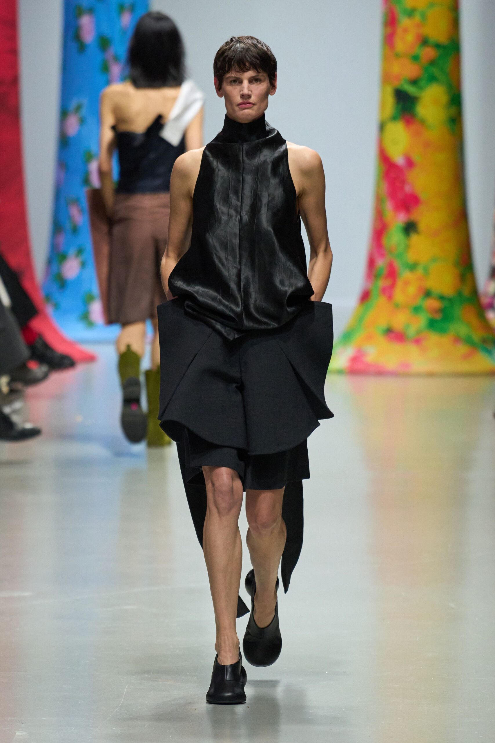 black silk sleeveless top with asymmetric shorts