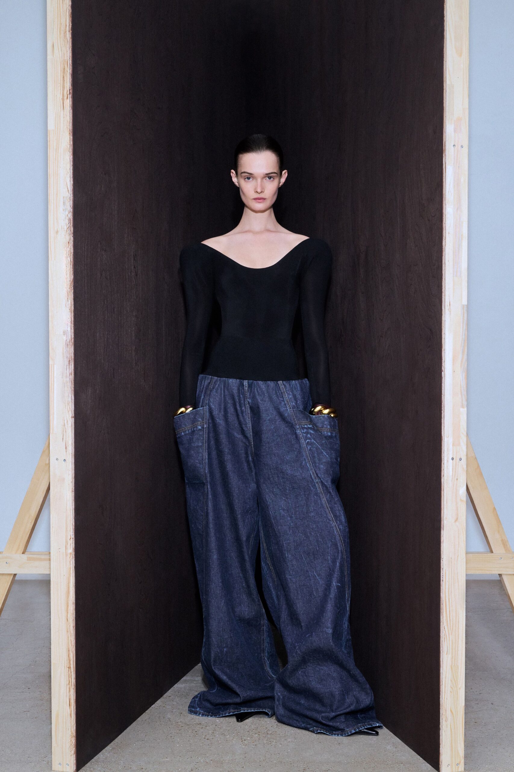 black fitted top and blue denim pants