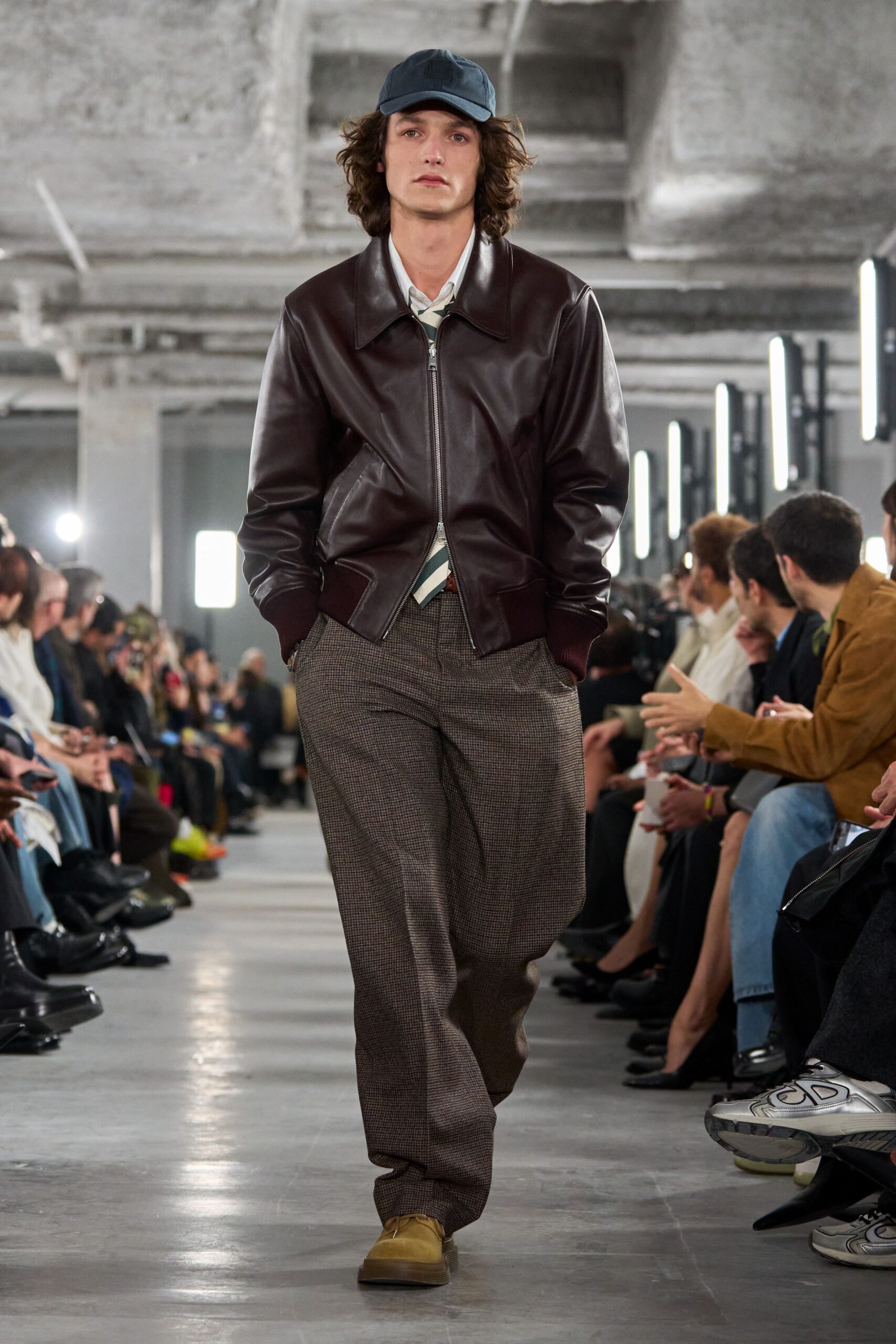 brown leather jacket with gray pants