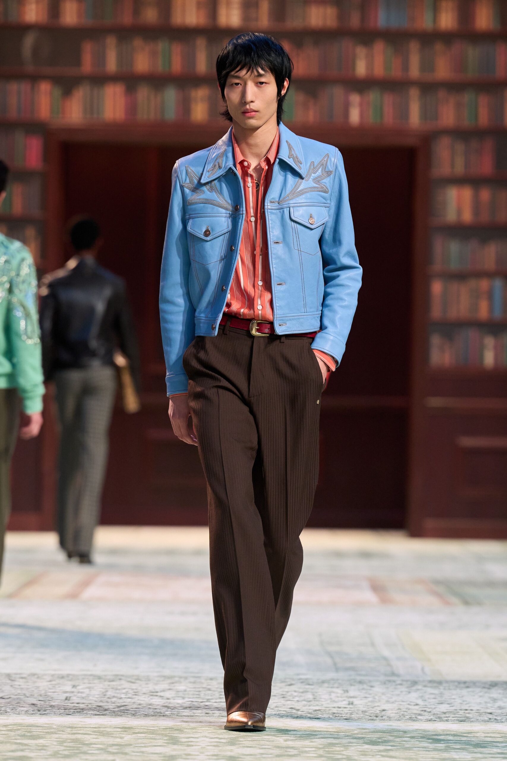 blue denim jacket orange shirt brown pants