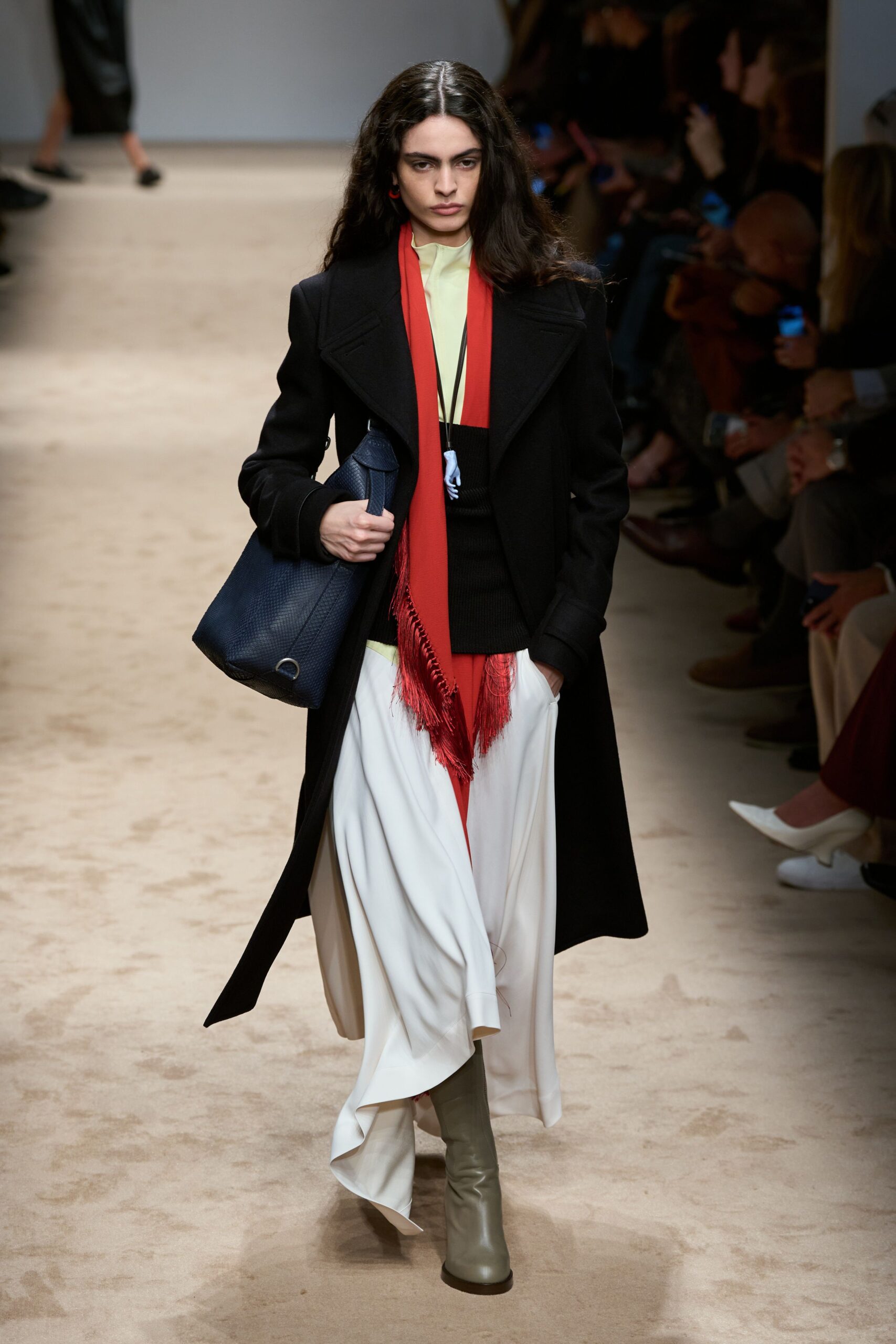 black wool coat with red scarf