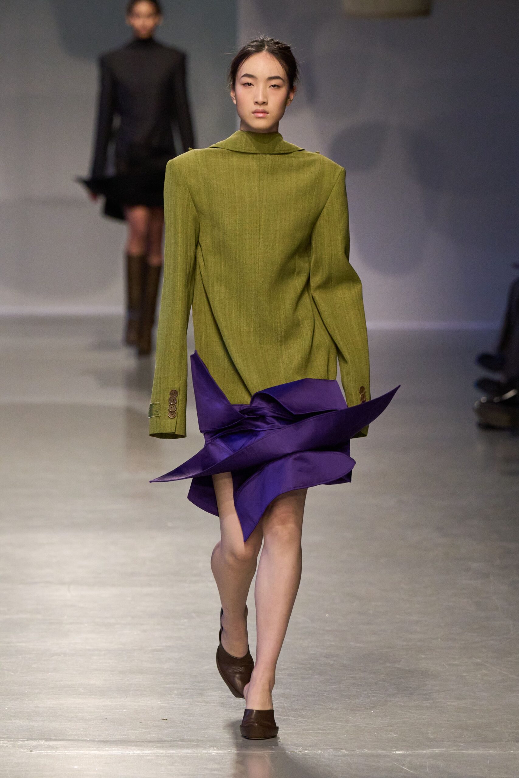 green structured blazer with asymmetric purple skirt