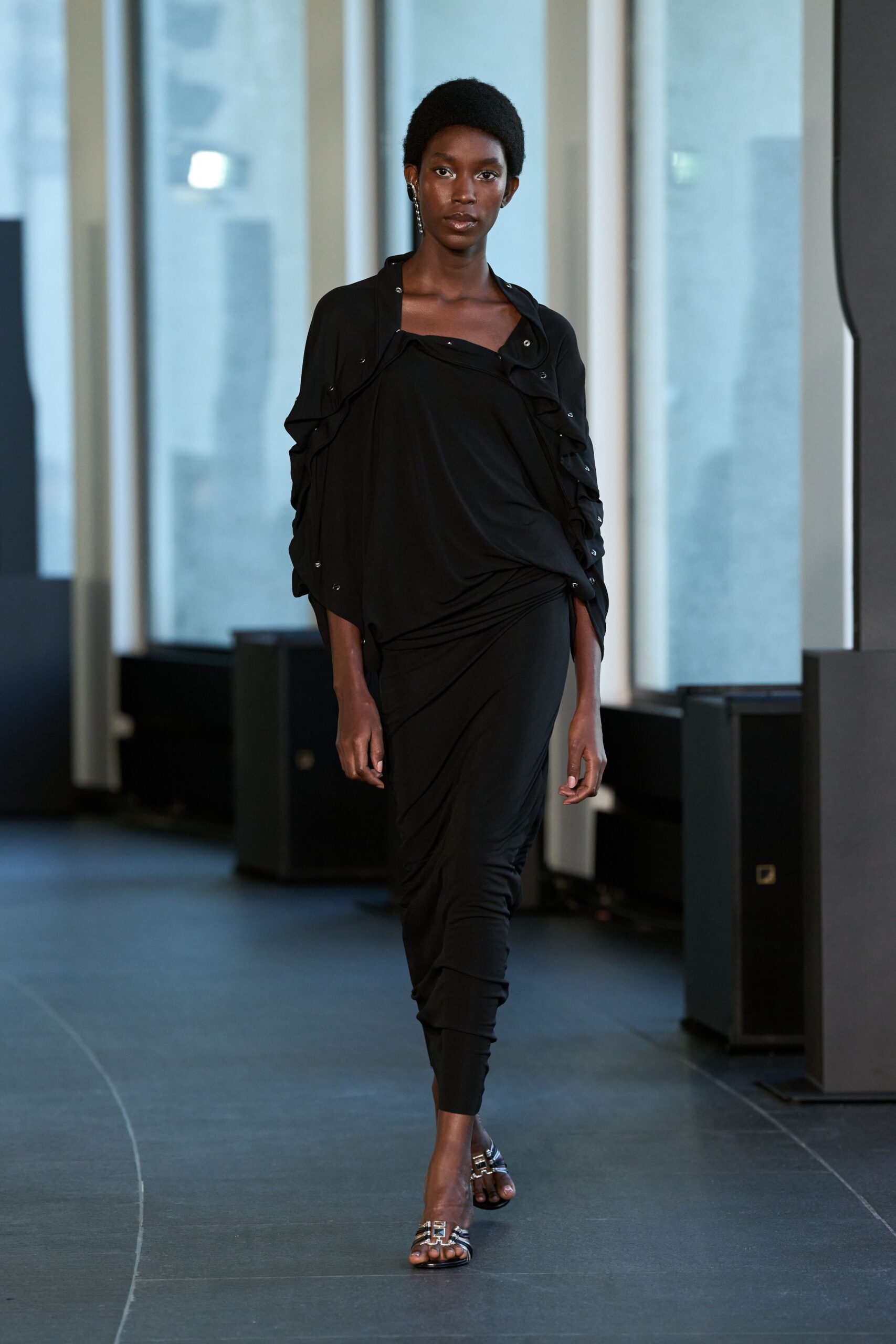 black fitted draped dress with silver shoes