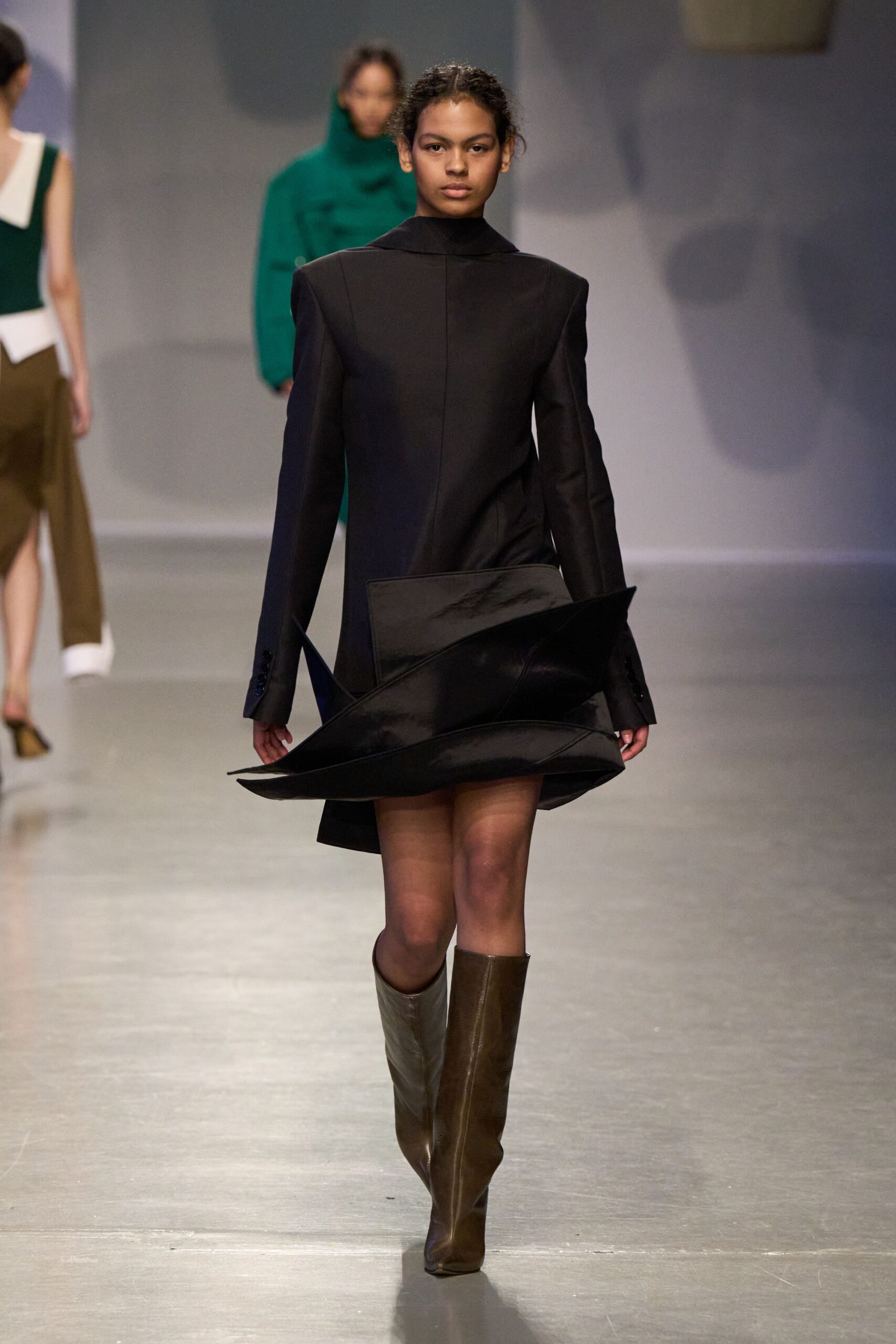 black asymmetric mini dress with brown boots