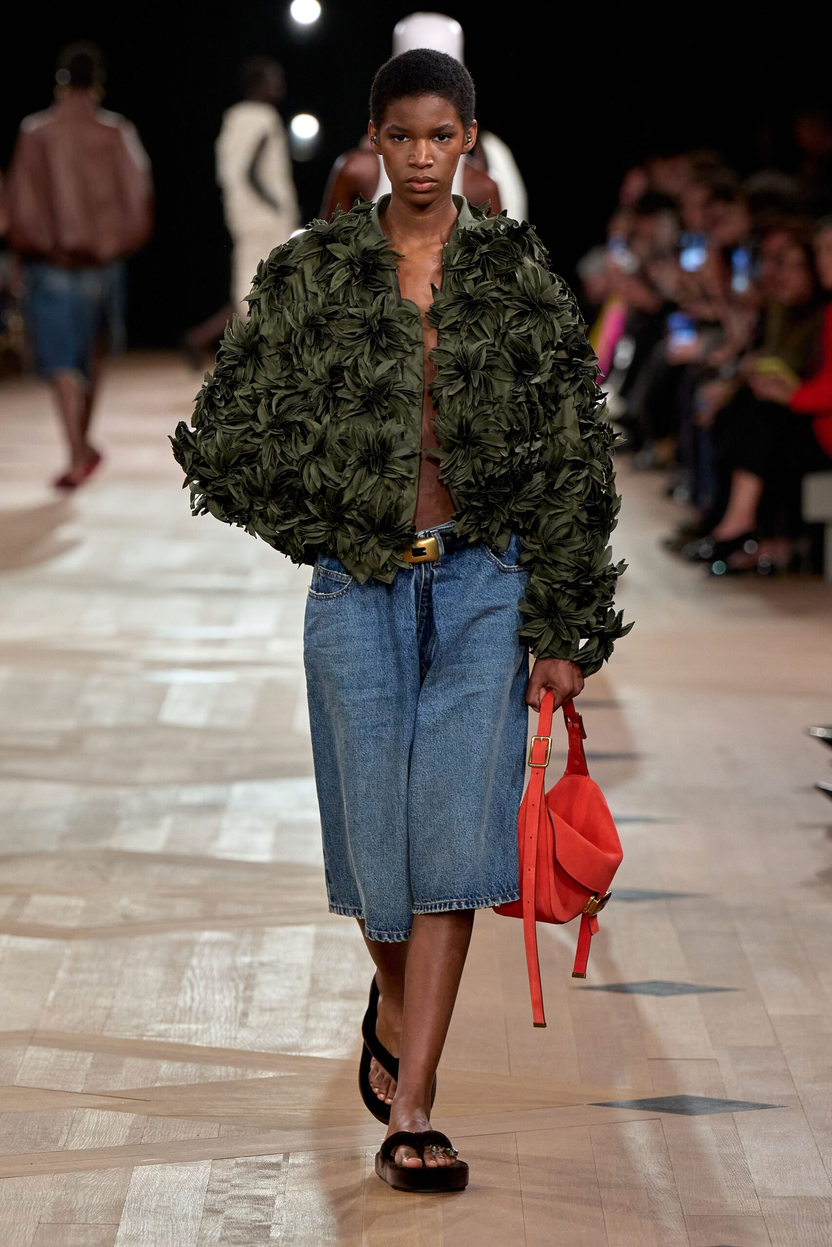 green layered jacket with denim pants