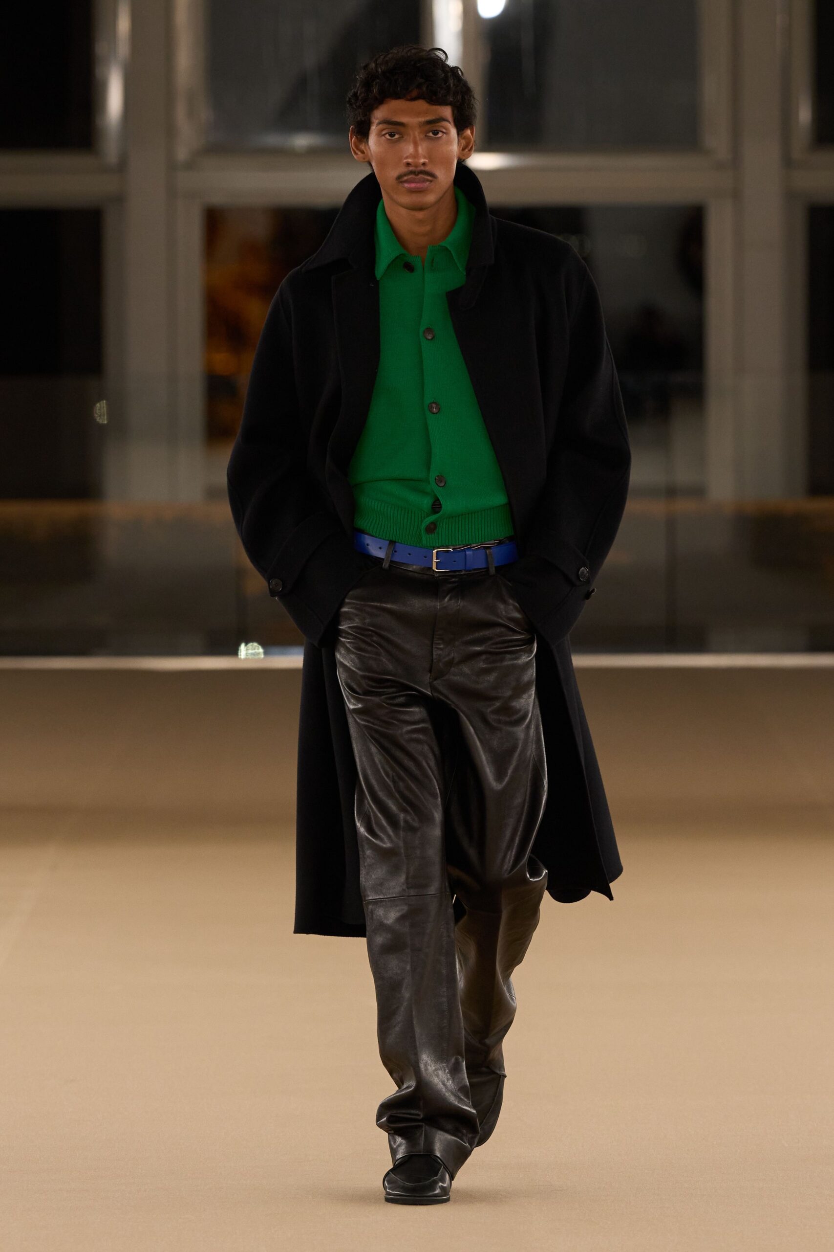 black coat green shirt leather pants