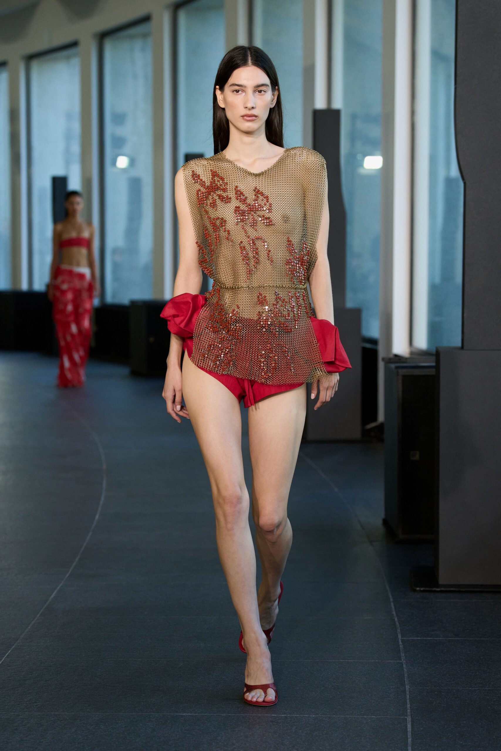 beige mesh embroidered top with red shorts