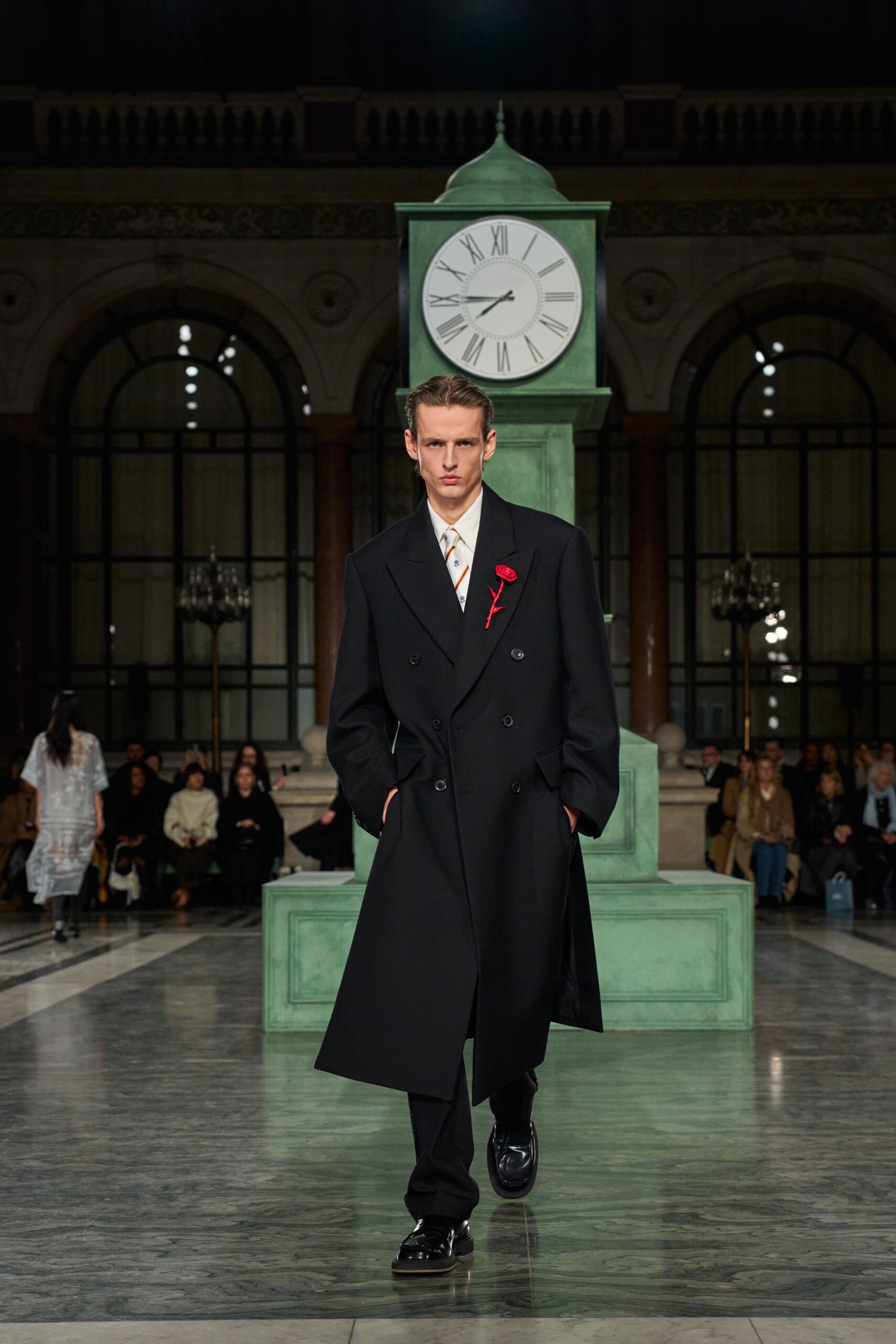 black tailored coat with red accessory