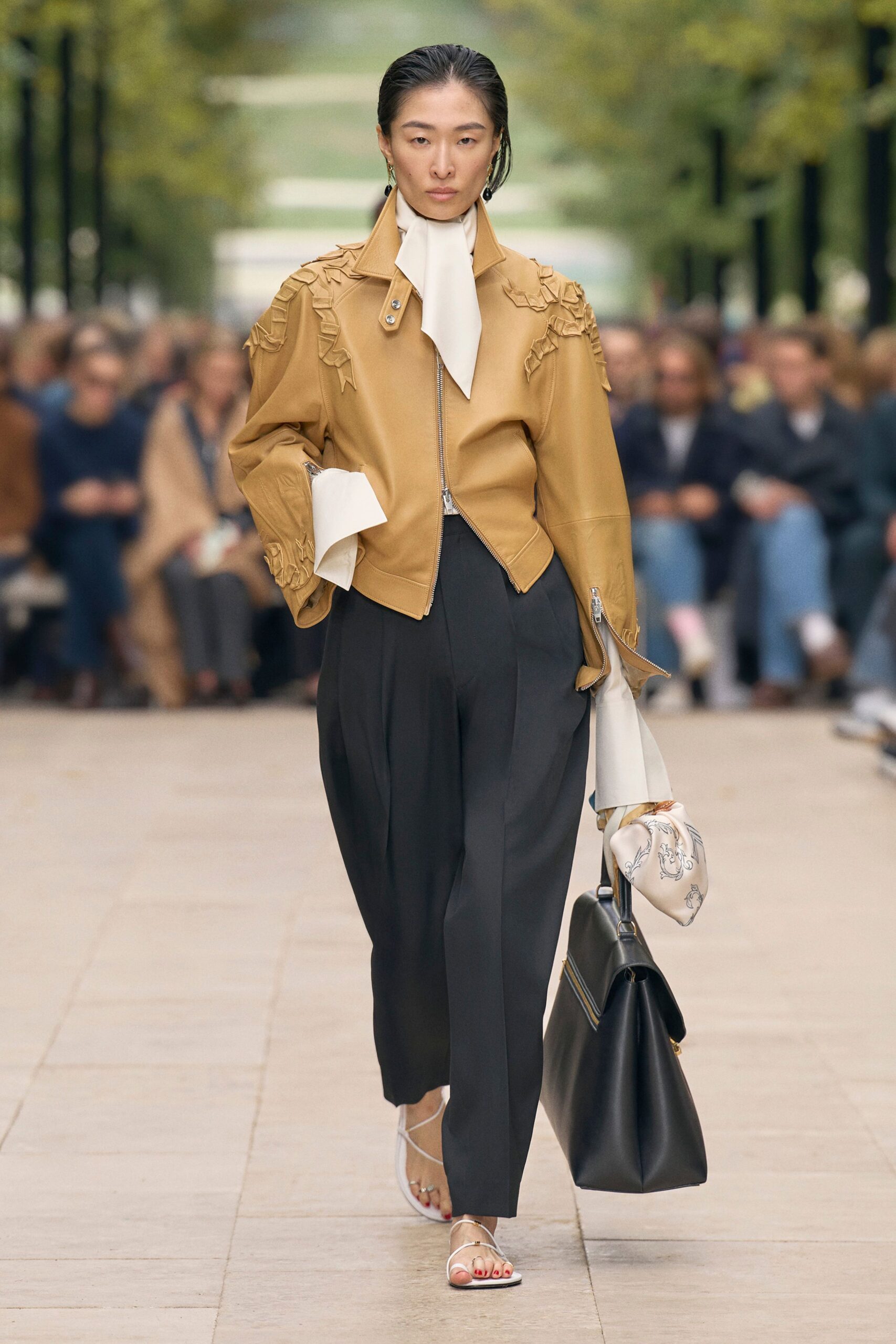 brown leather jacket with black pants