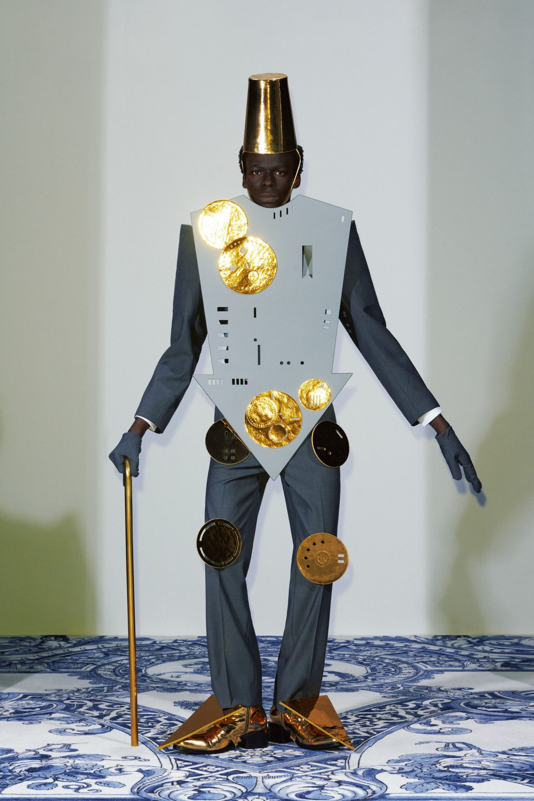 gray structured suit with gold hat