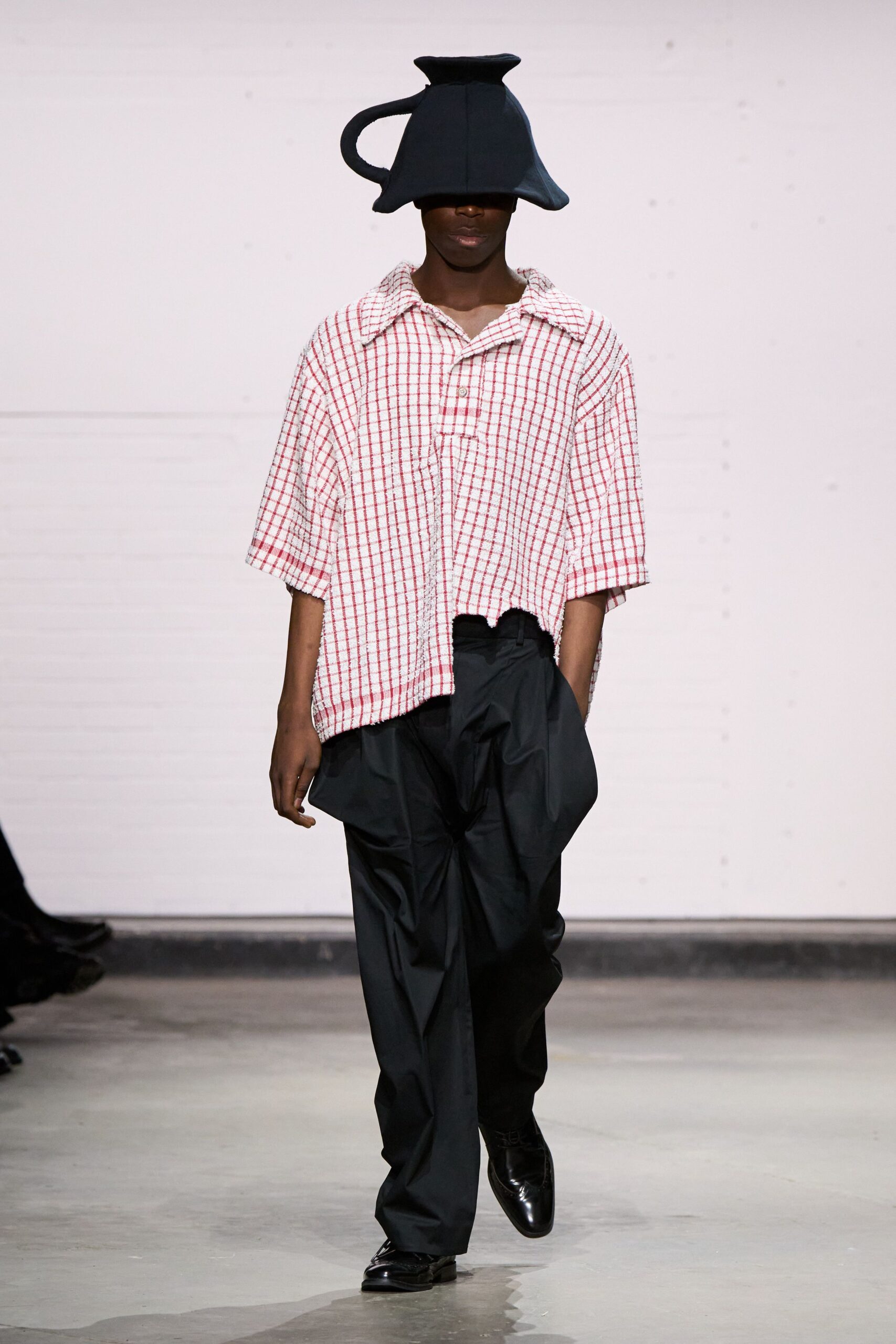 red and white checked shirt with black pants