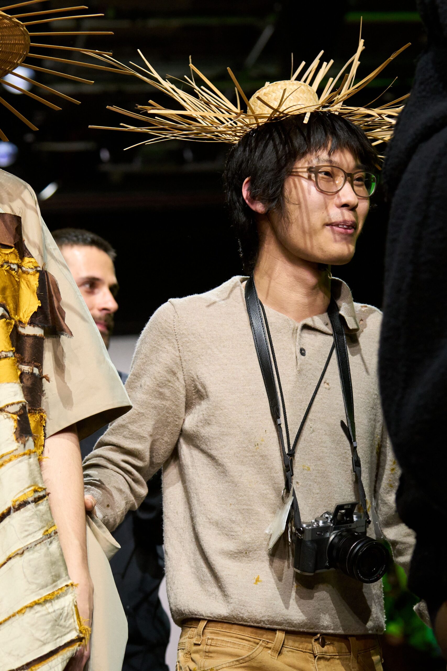 beige shirt brown pants straw hat