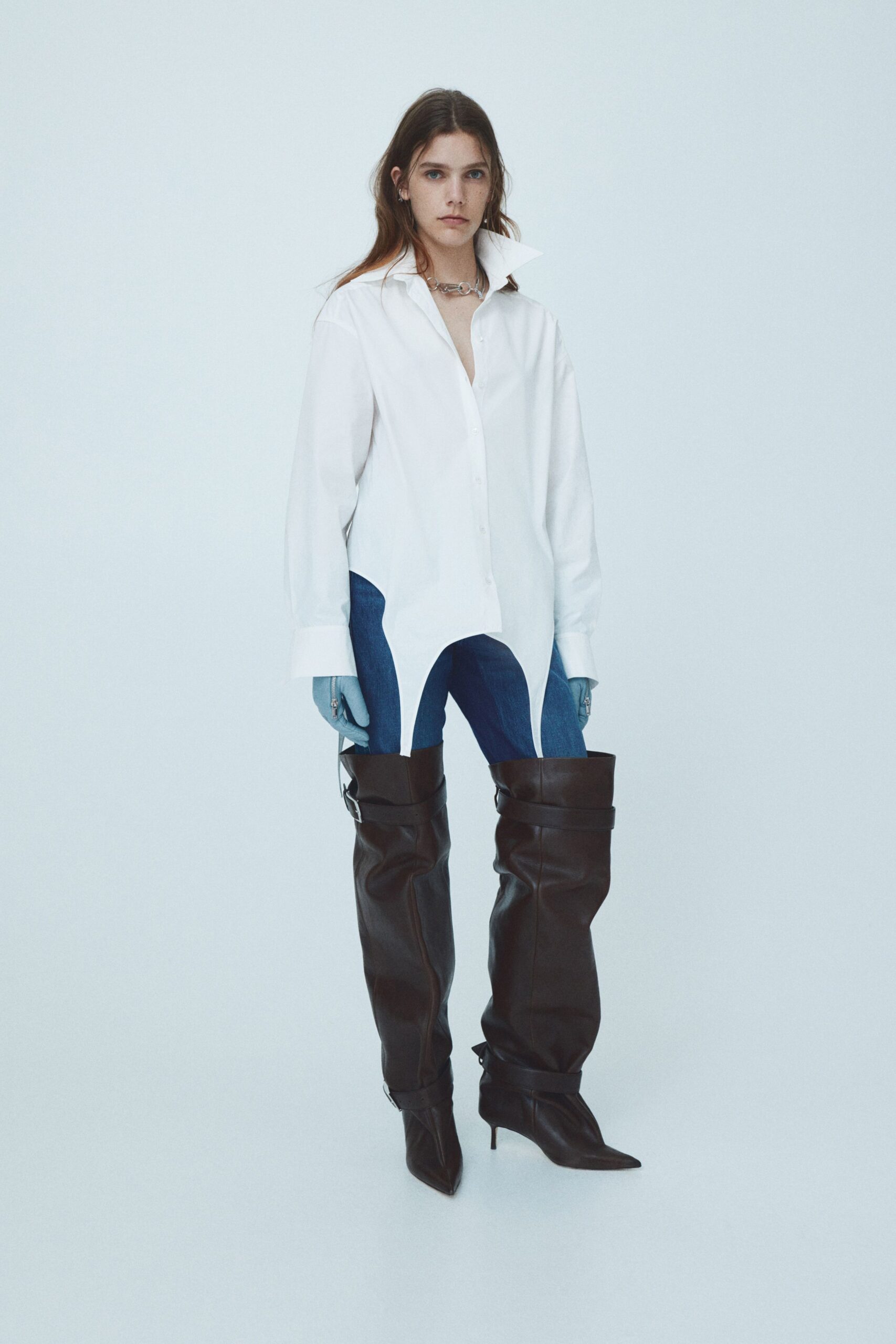 white relaxed shirt with blue jeans and brown boots