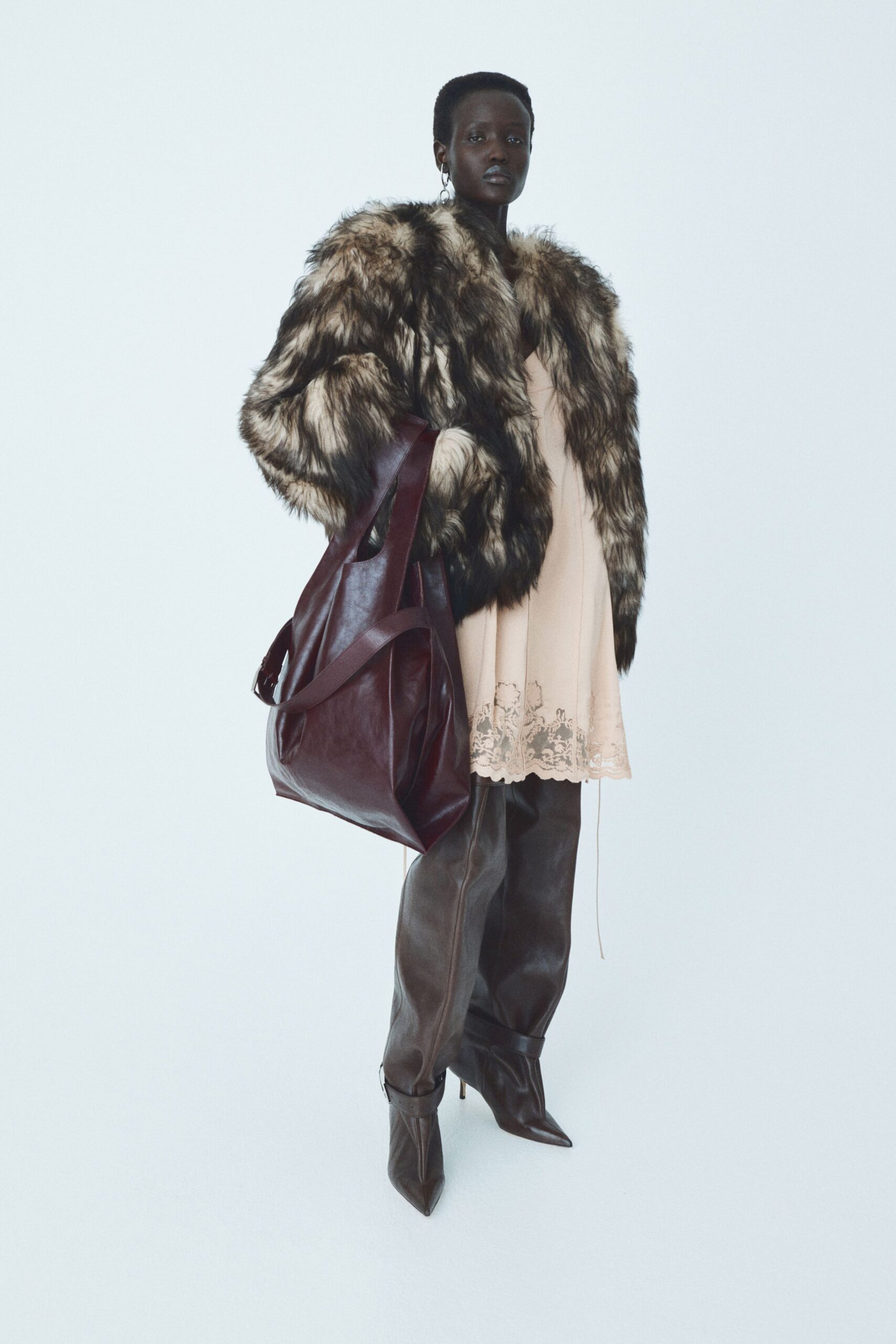 brown faux-fur coat with pink dress