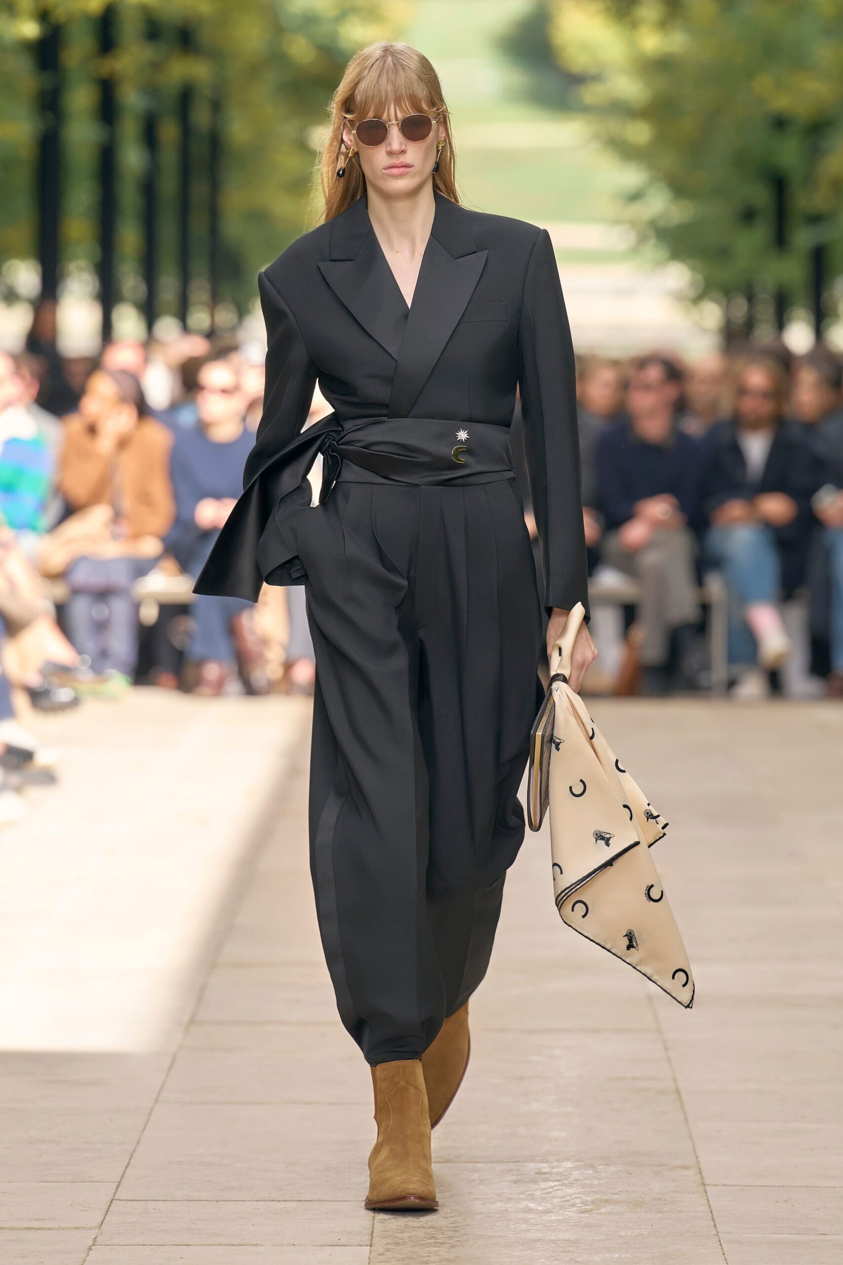 black tailored suit with beige bag