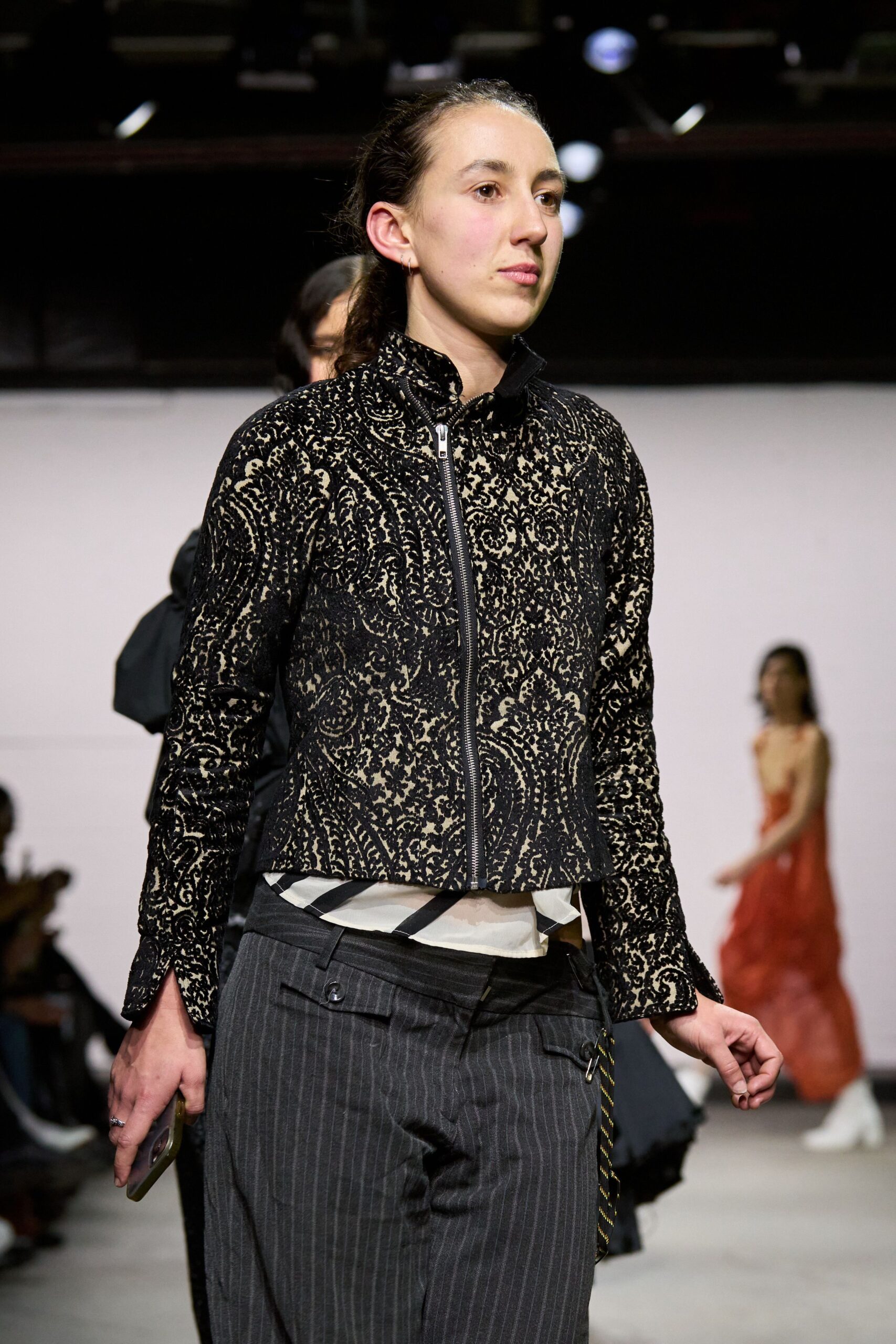 black embroidered jacket with gray pants