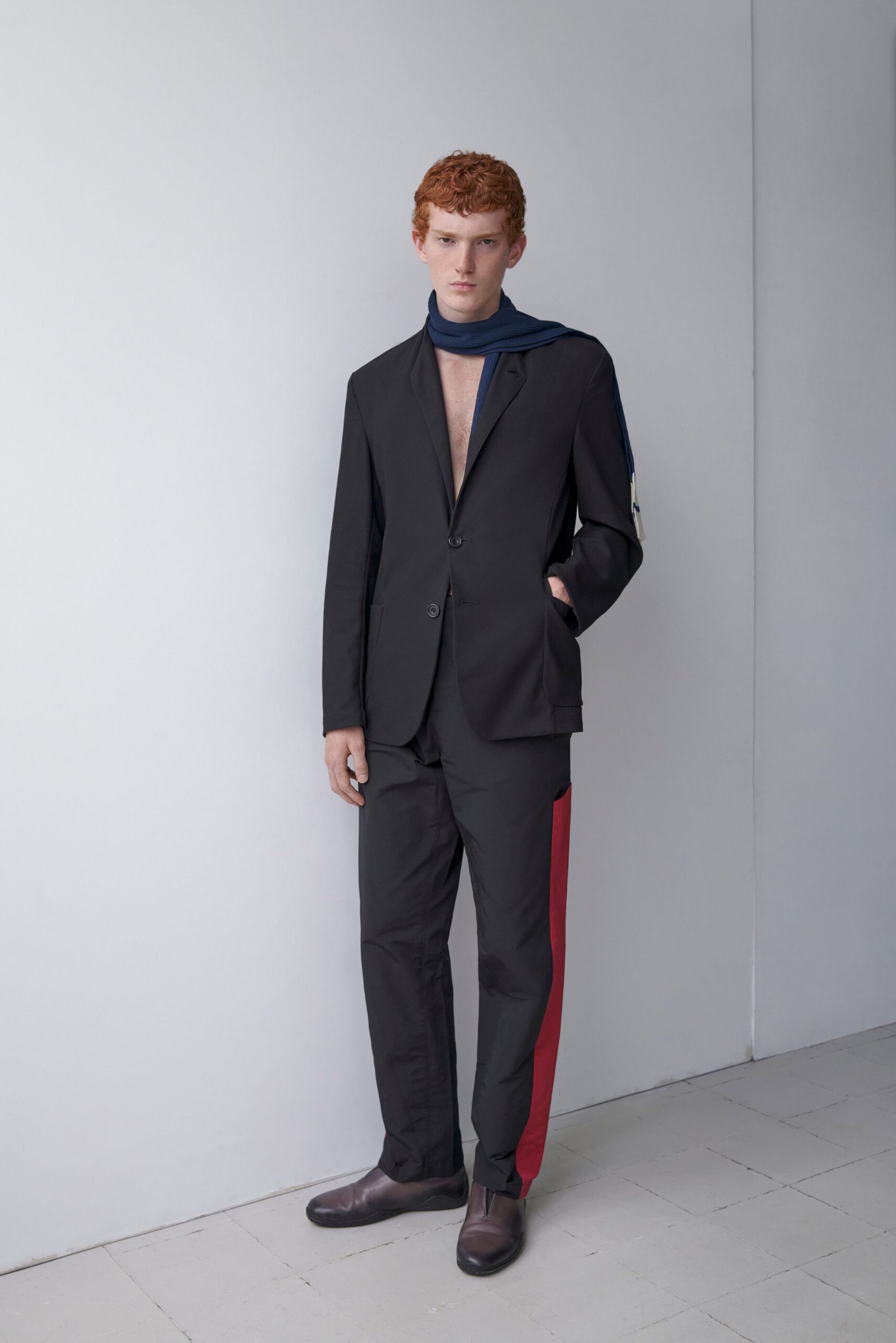 black tailored suit with blue scarf
