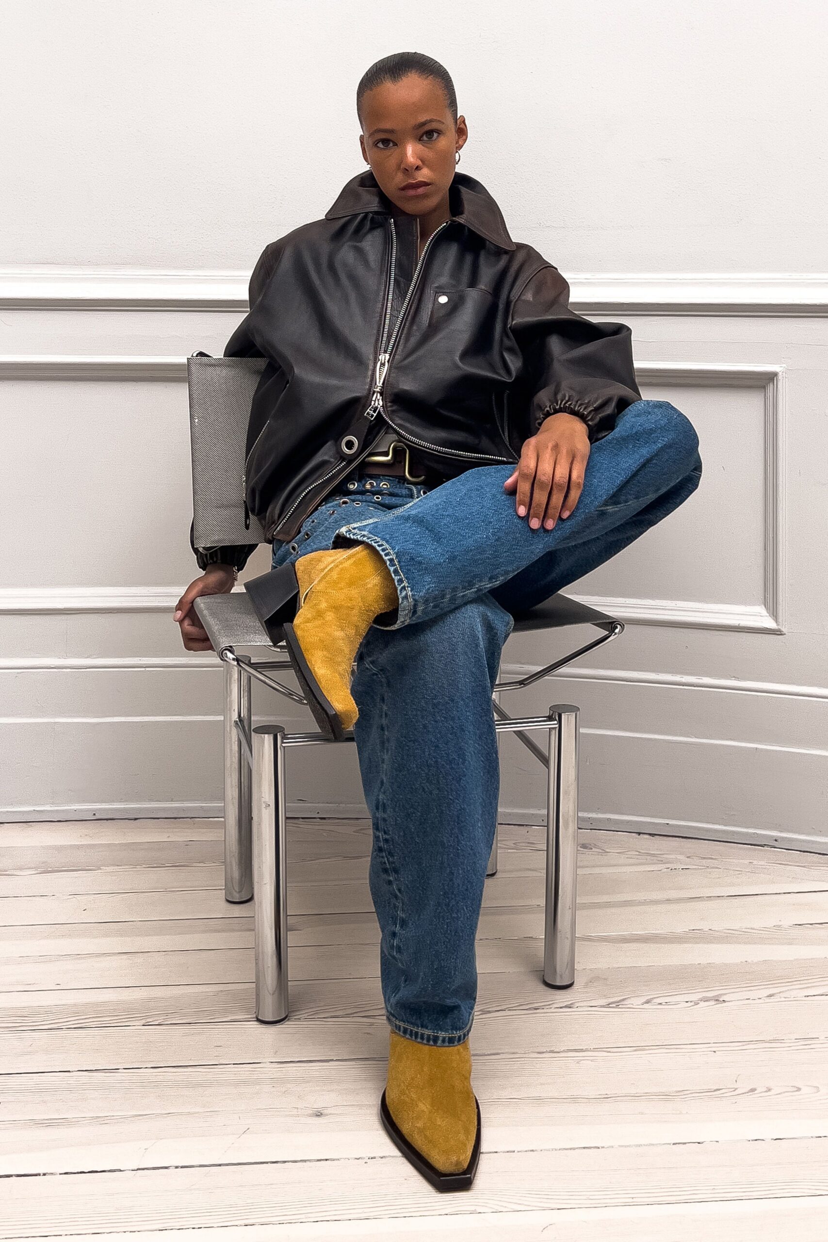 black leather relaxed jacket with blue jeans