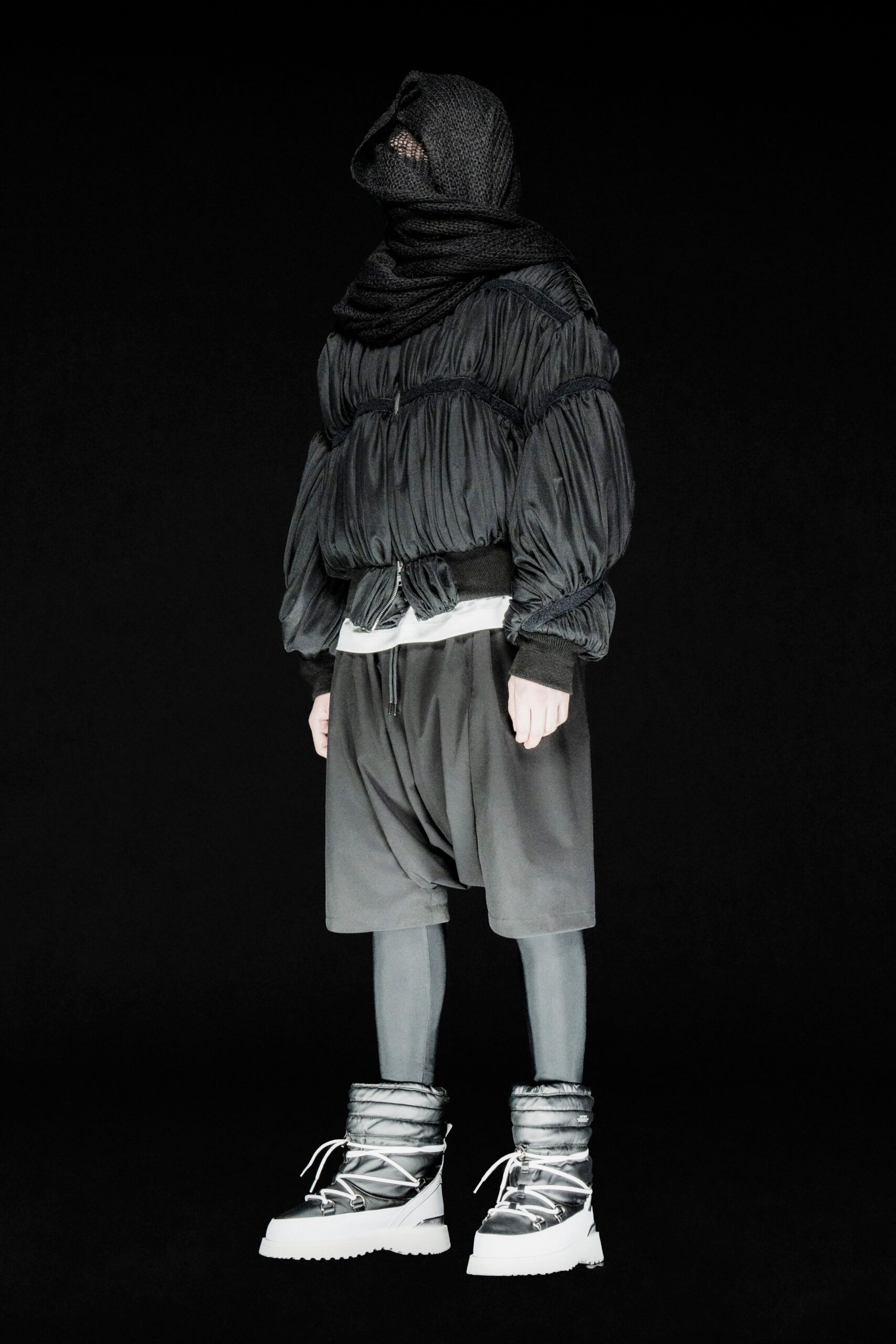 black pleated jacket with gray shorts