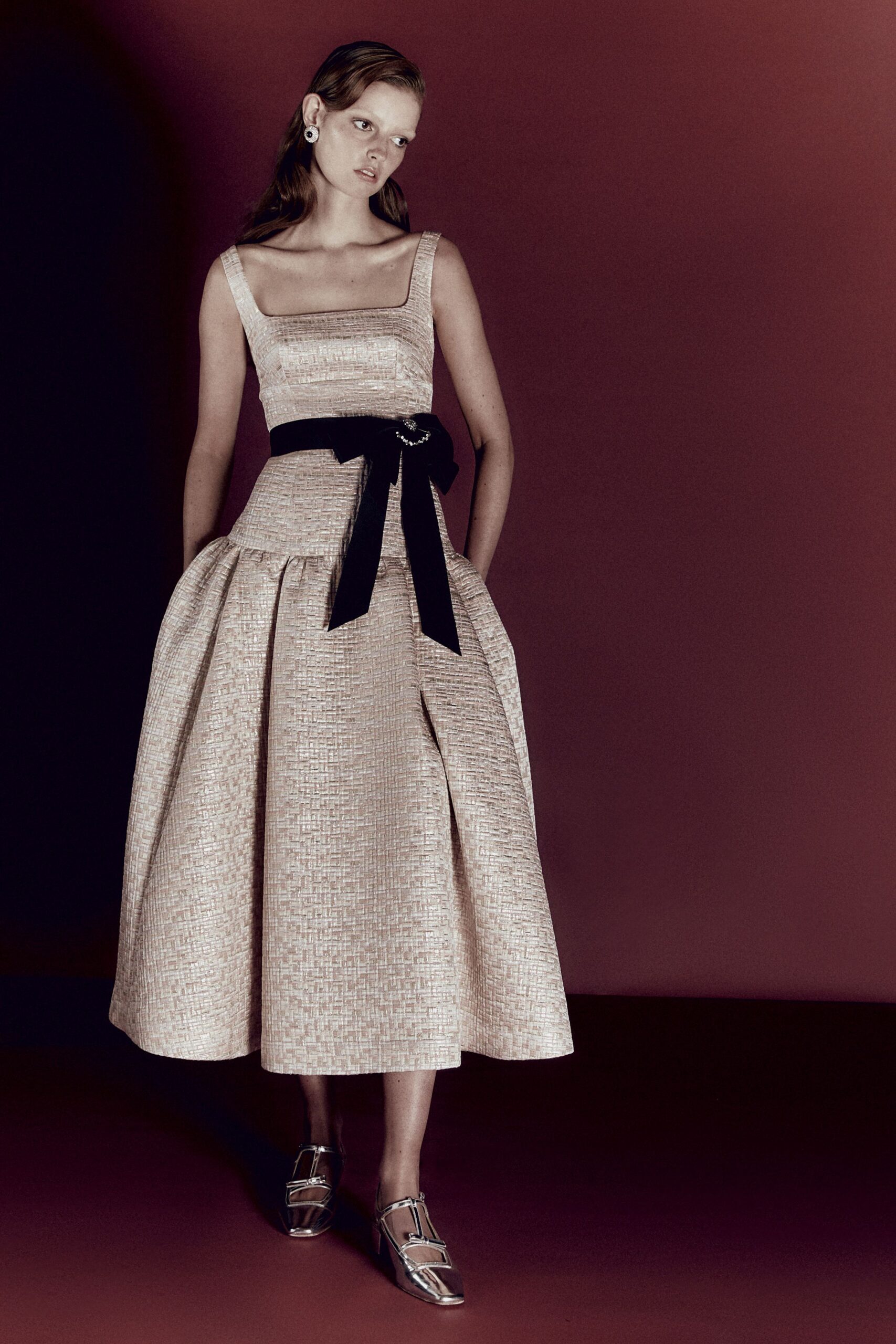 beige pleated midi dress with silver shoes