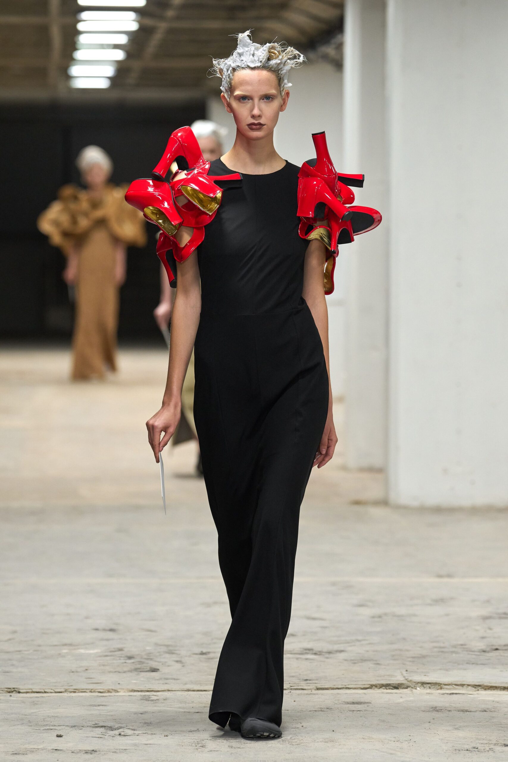 black fitted jumpsuit with red shoes