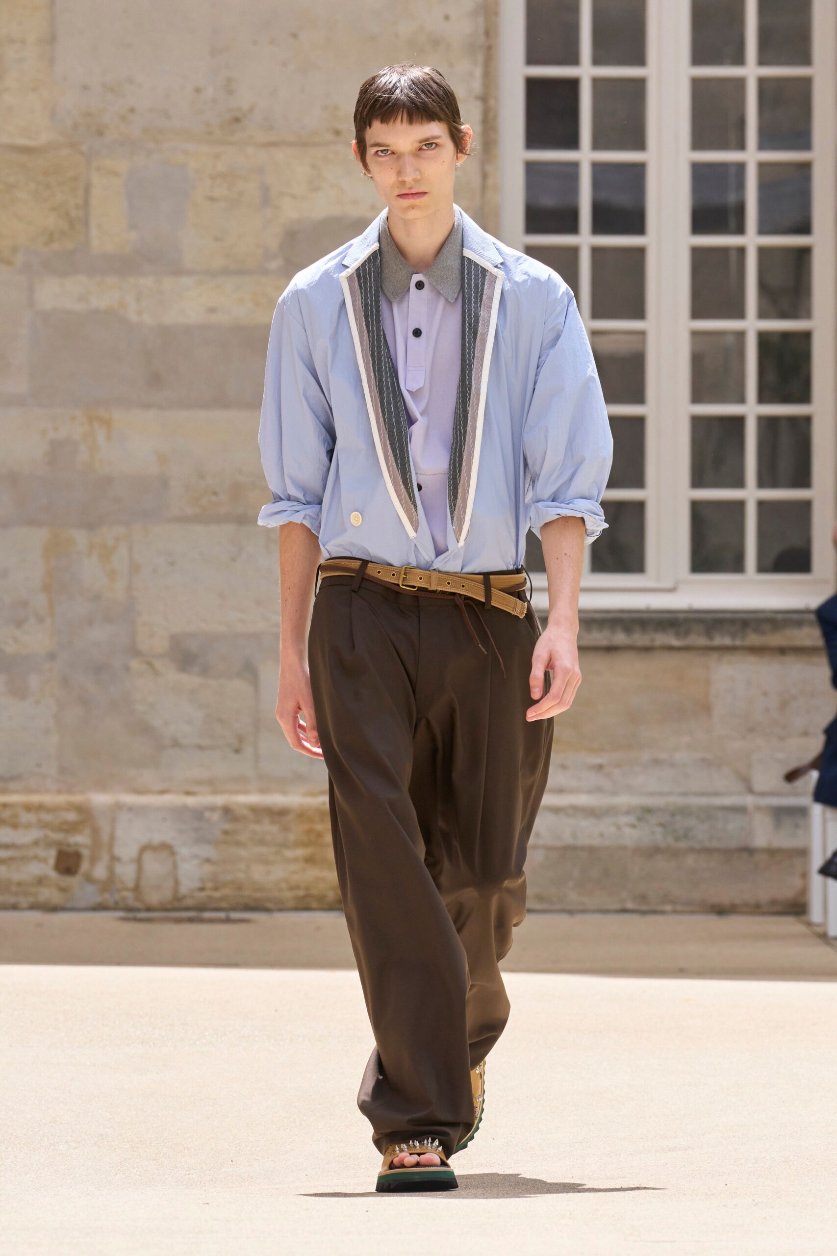 blue jacket gray shirt brown pants