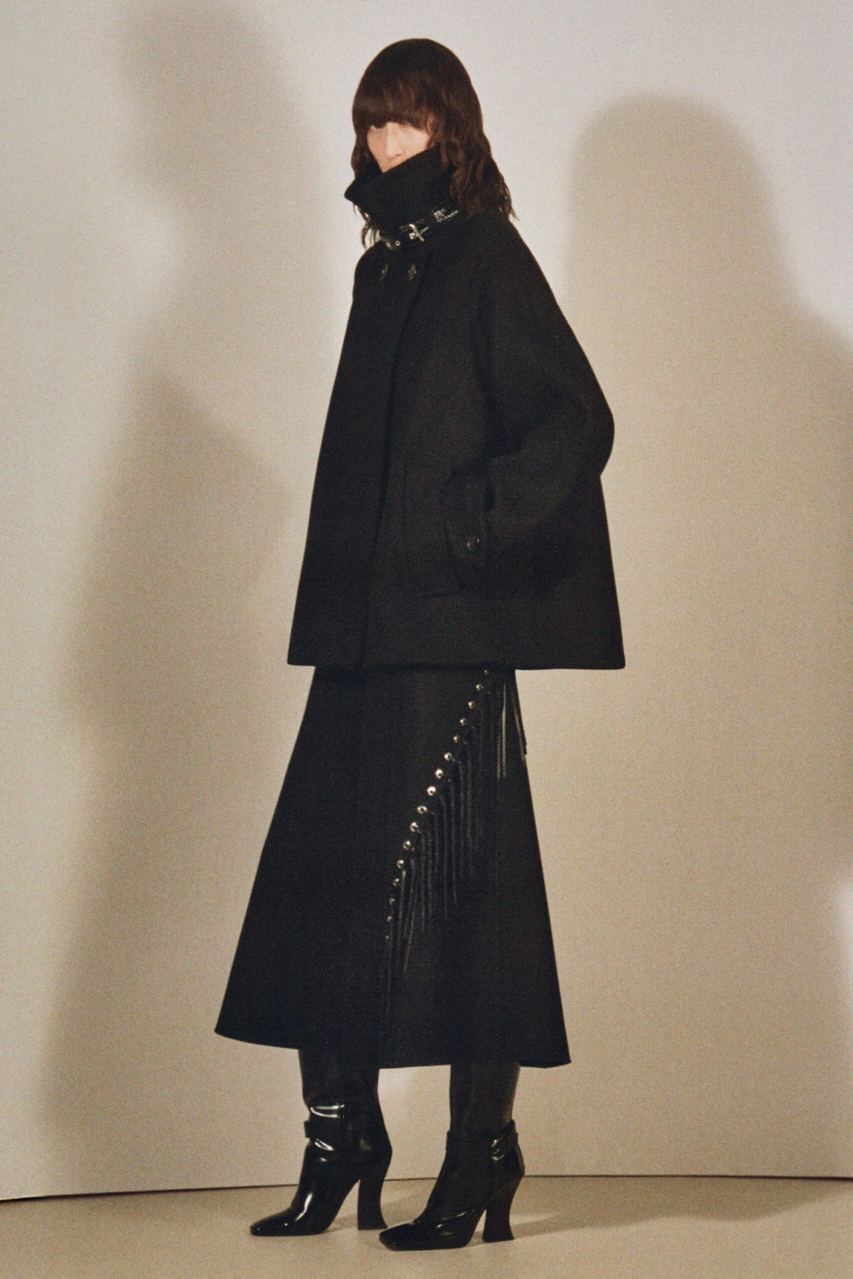 black oversized coat with fringed skirt