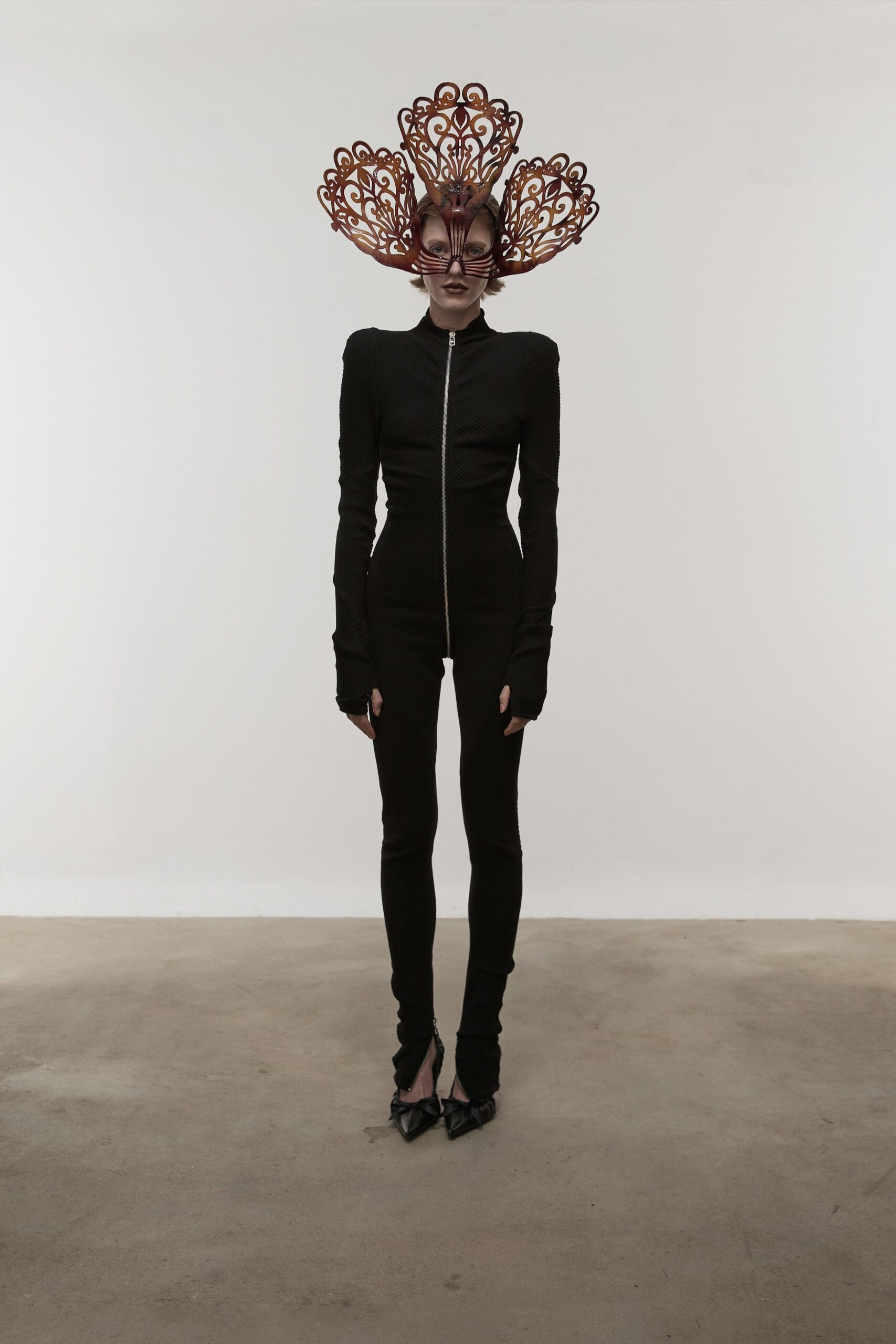 black fitted catsuit with red hat