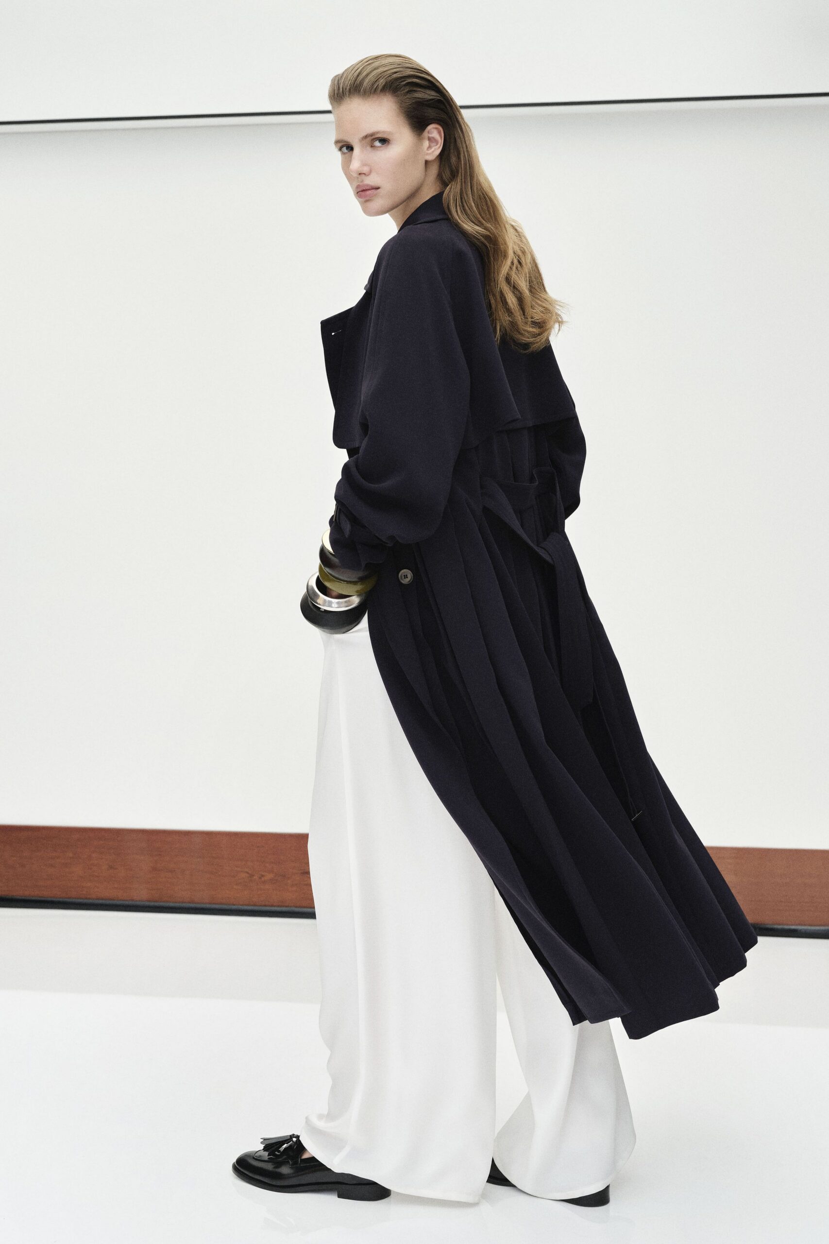 black wool coat white wide-leg pants