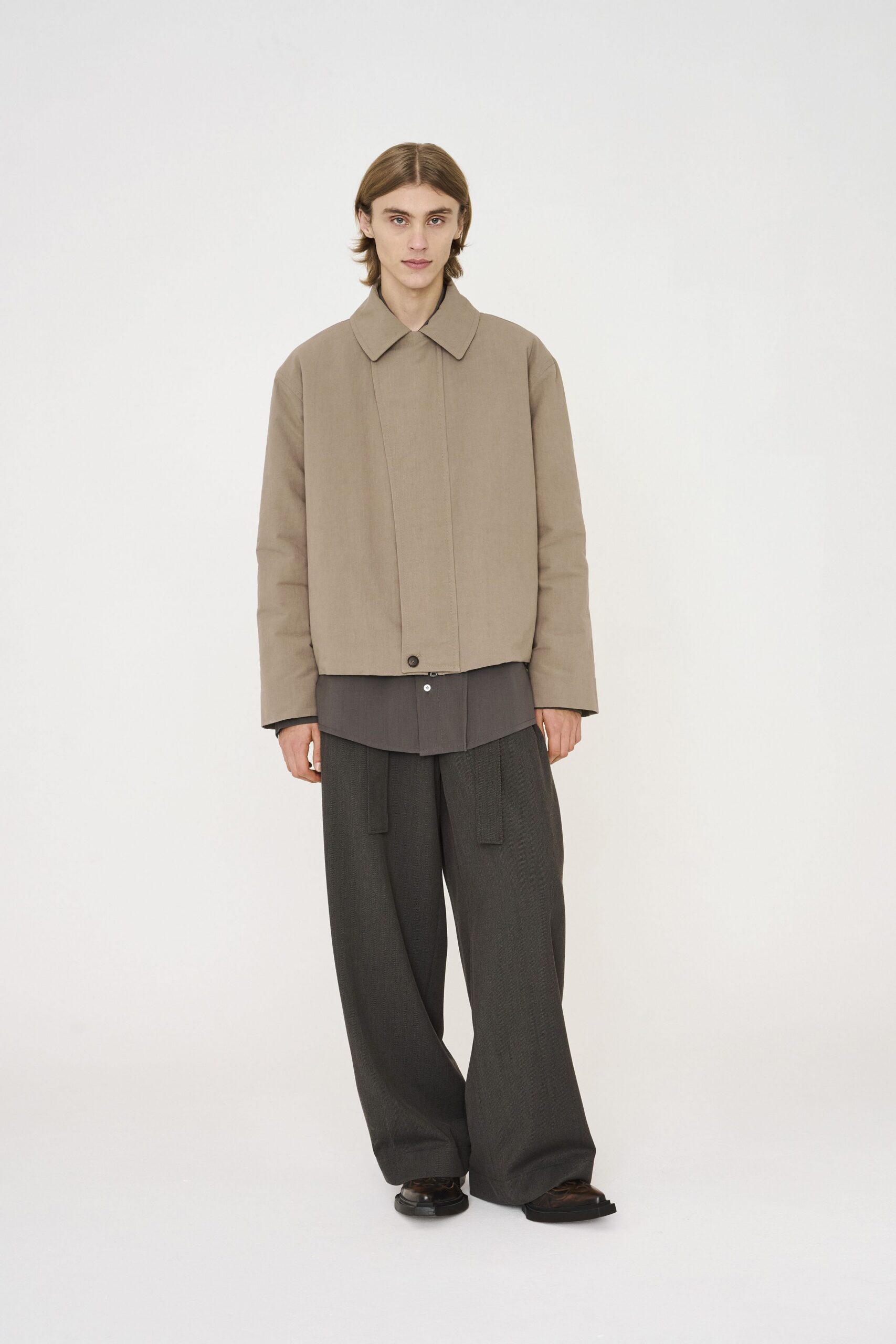 beige jacket gray shirt black pants