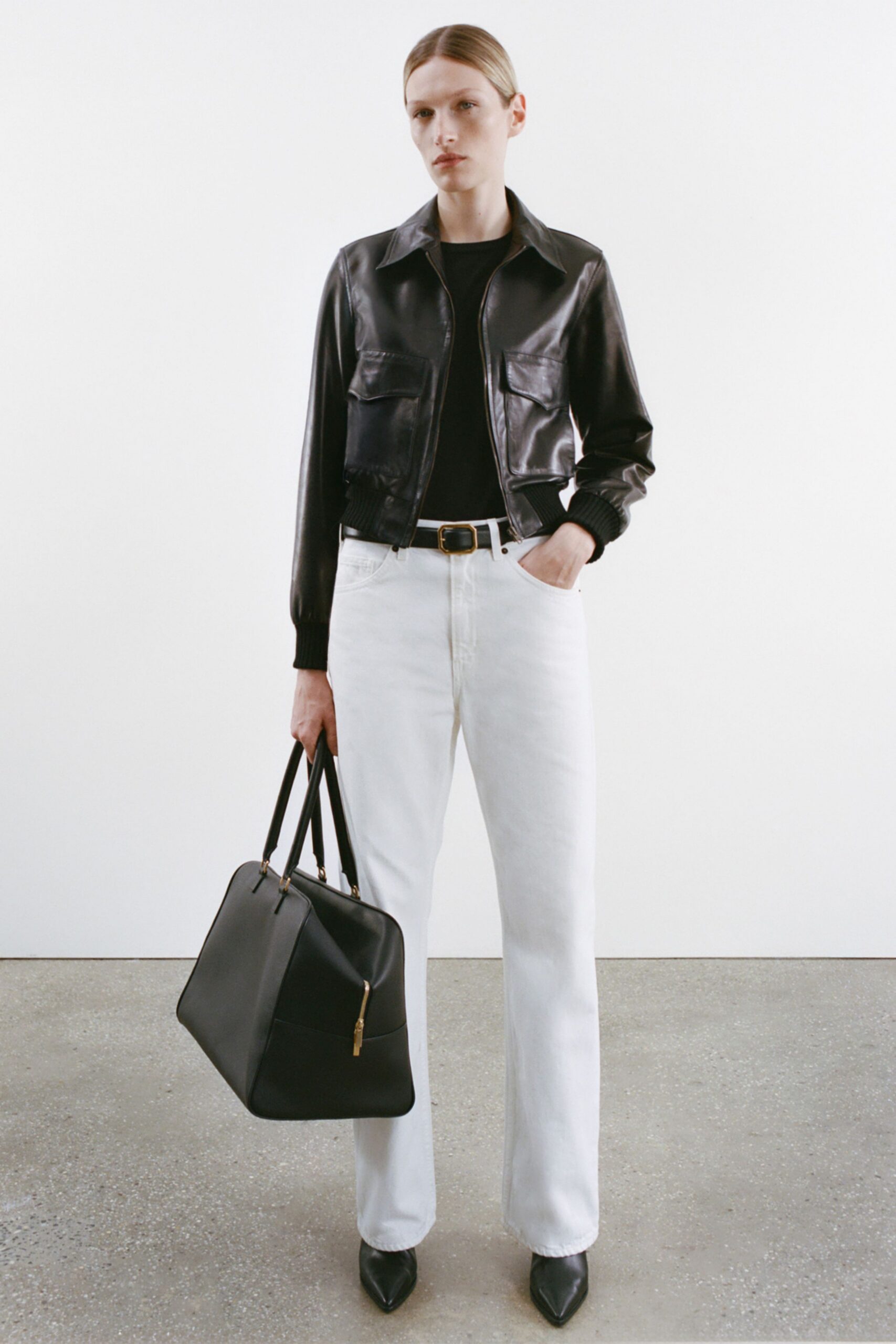 black leather jacket and white pants