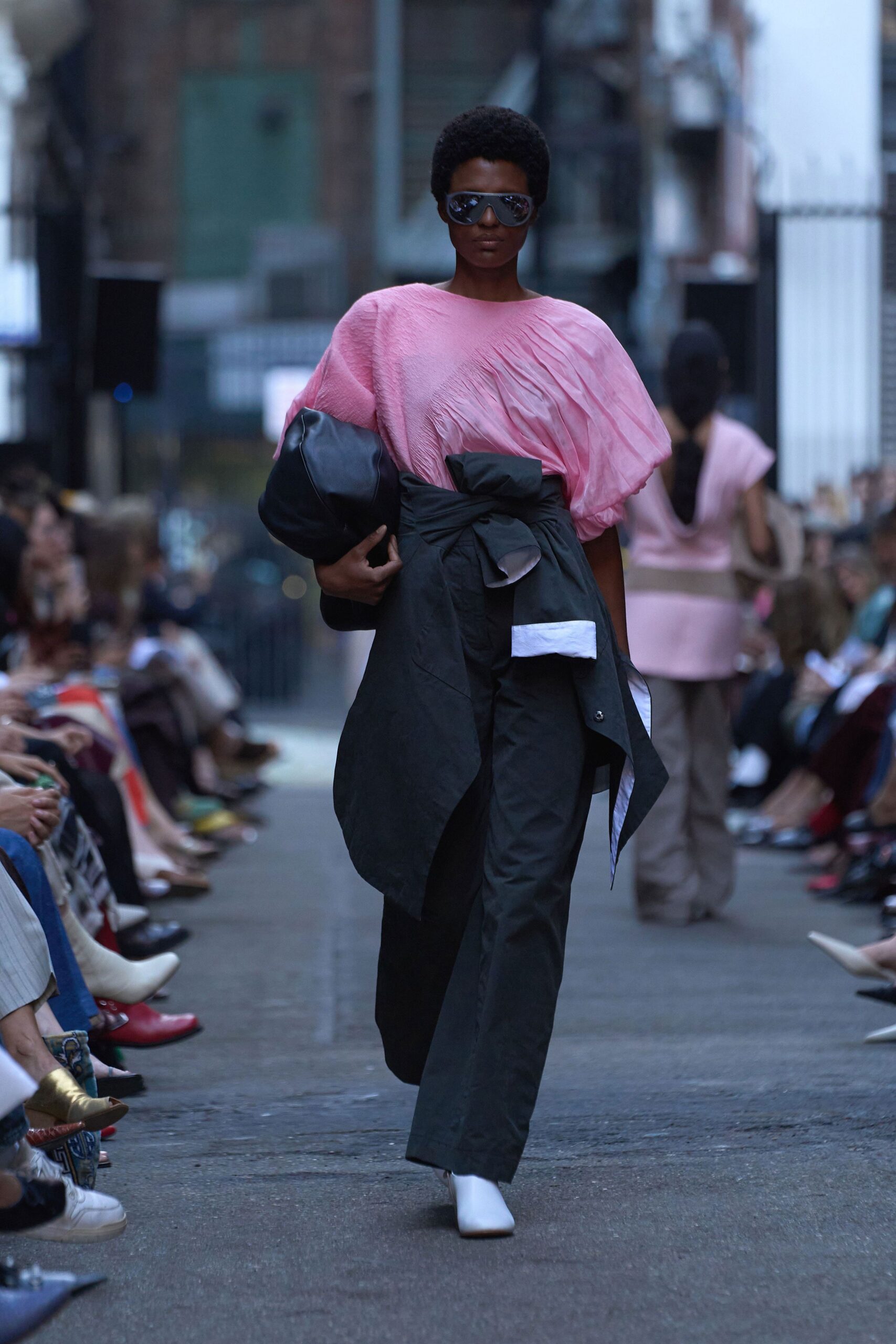 pink pleated top with gray pants