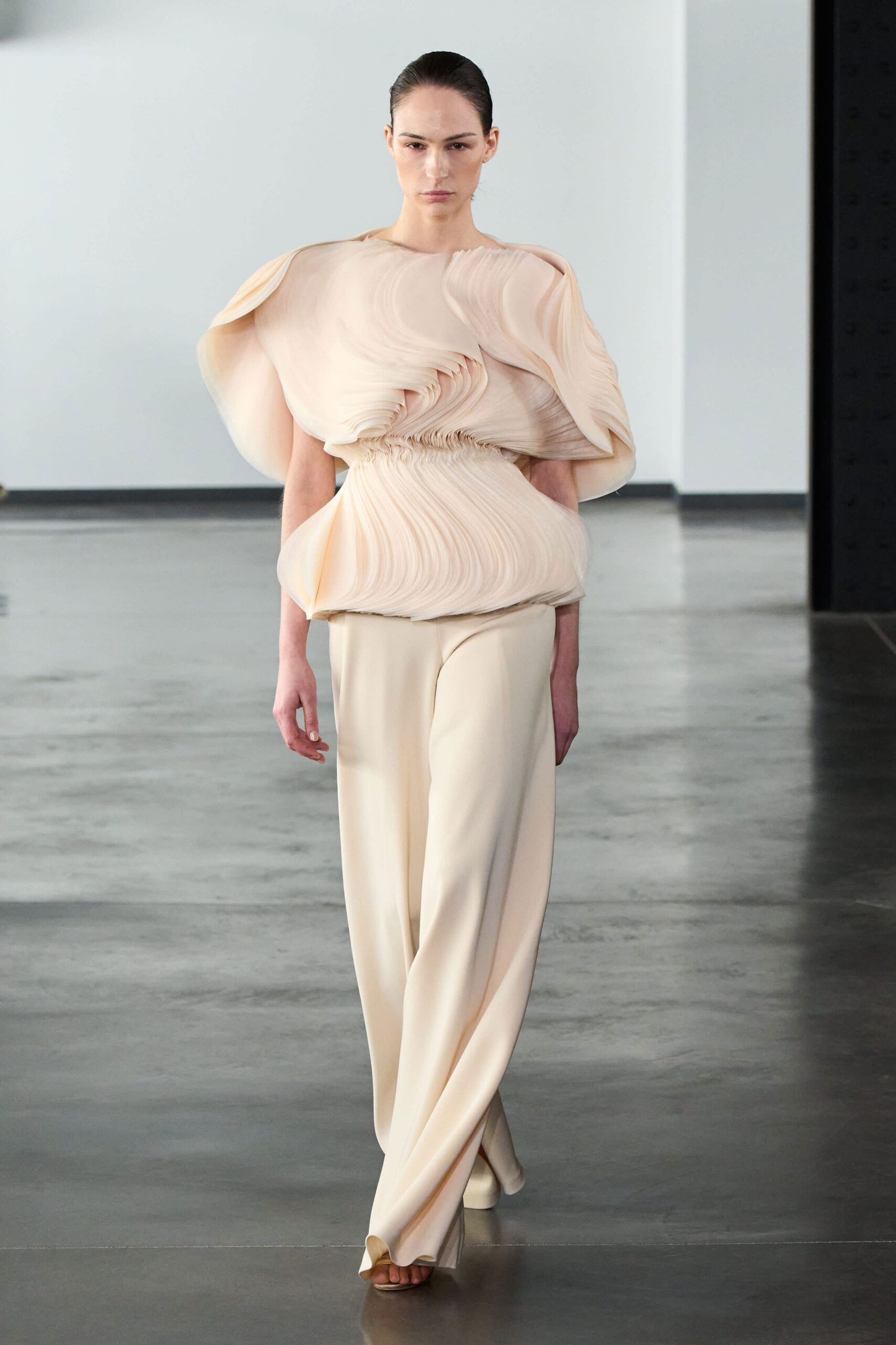 beige pleated top and relaxed pants
