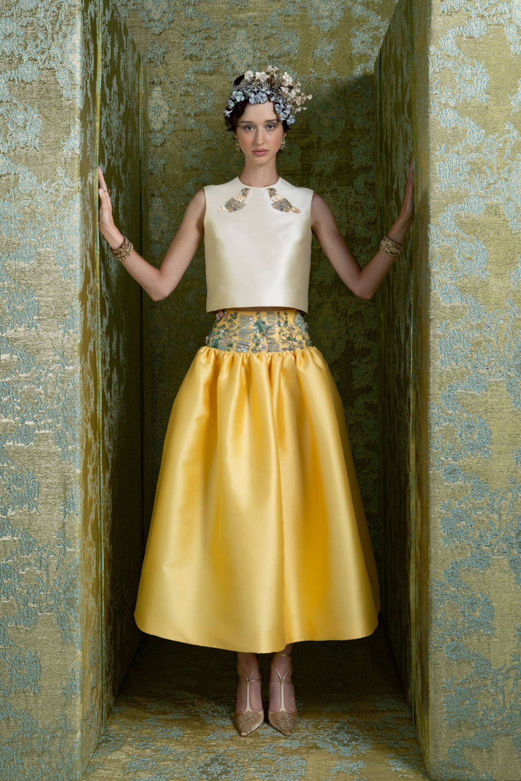 white silk sleeveless top and yellow midi skirt