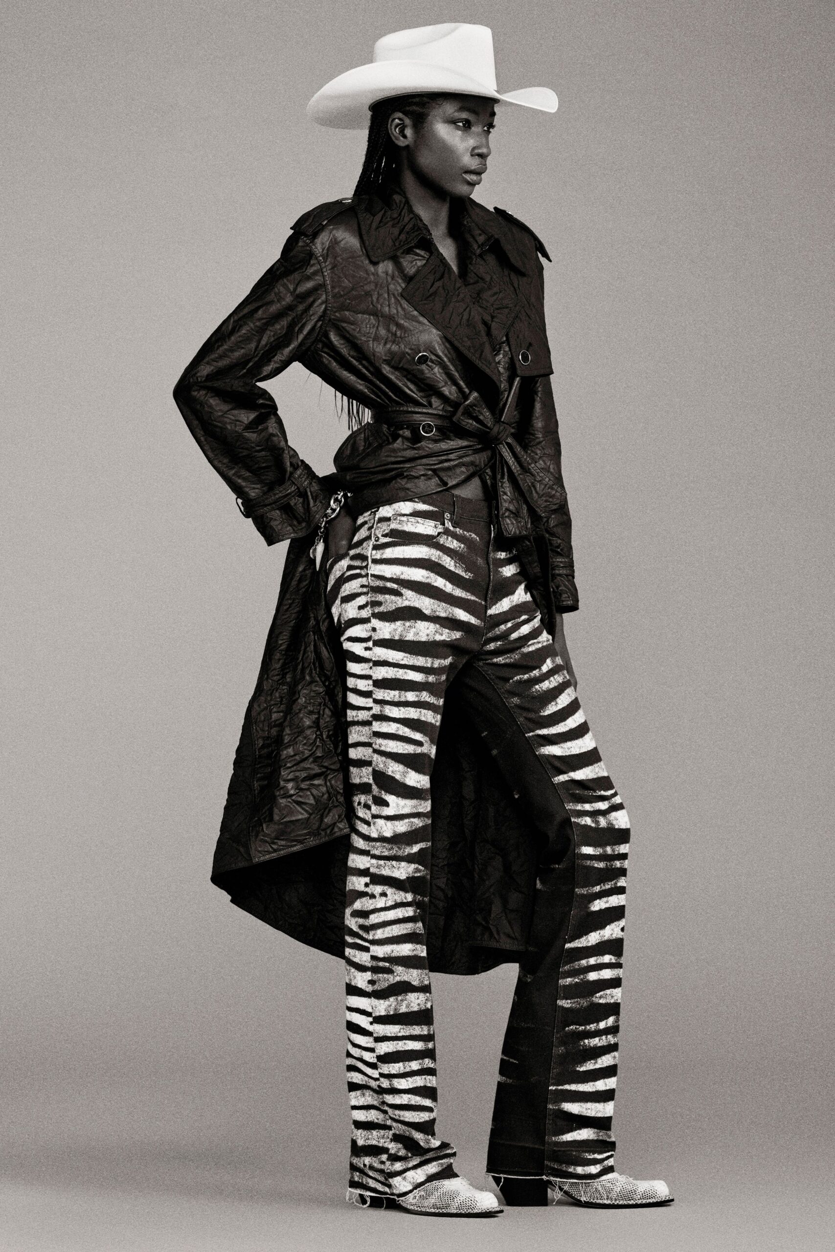 black leather trench coat with striped pants