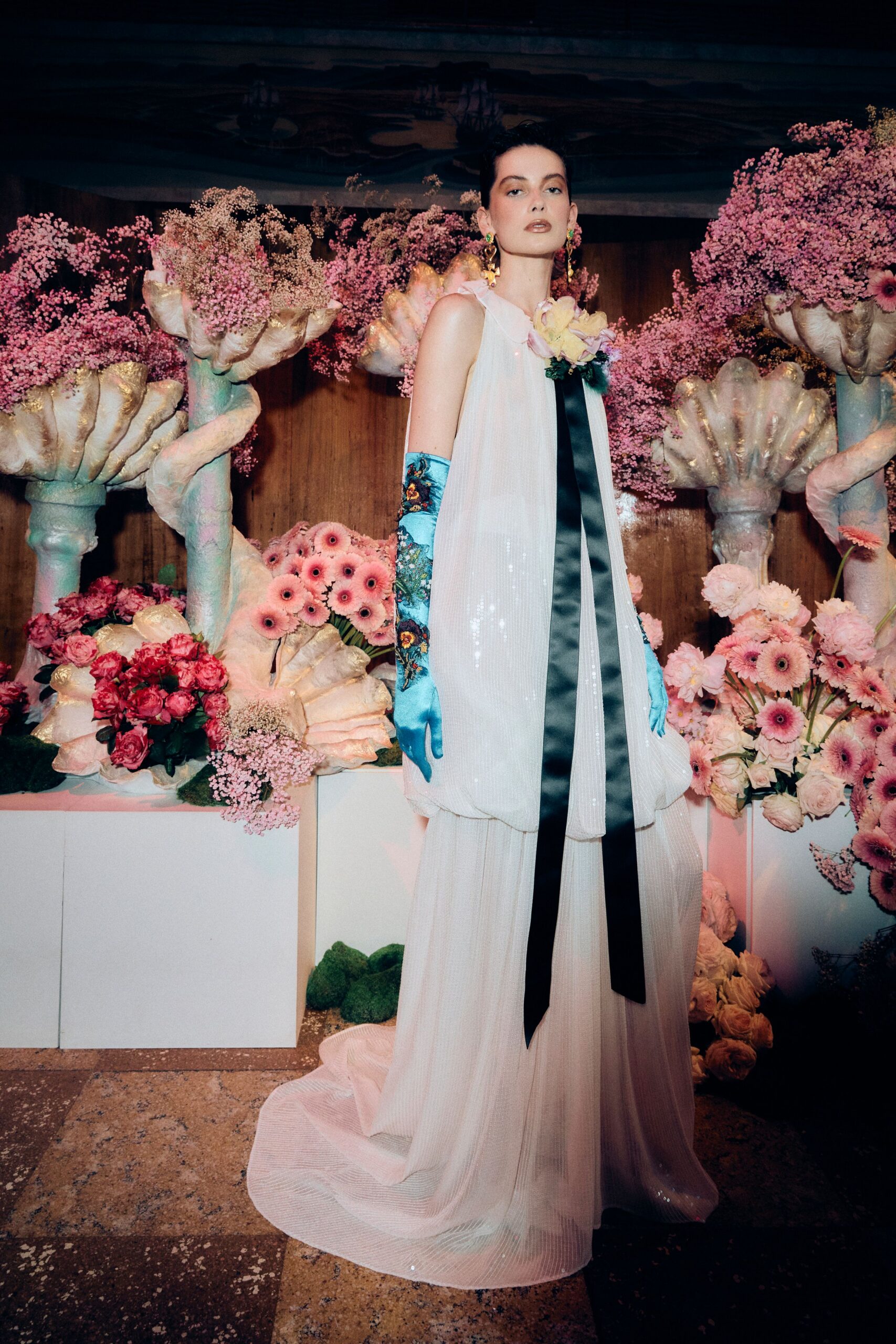 white silk relaxed gown with blue gloves