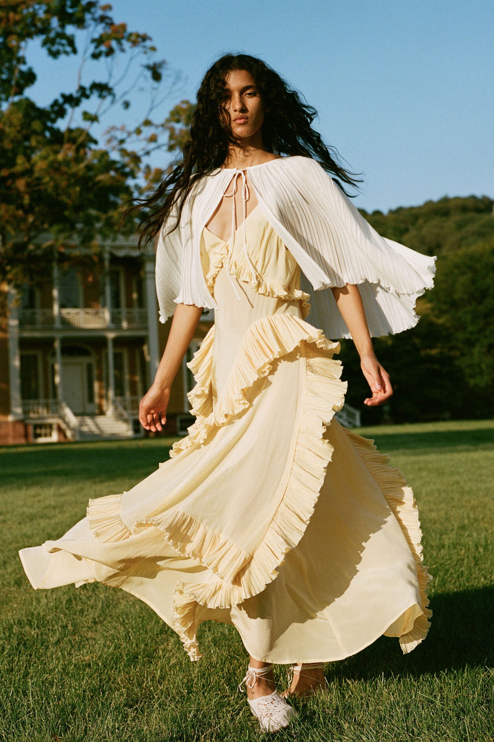 white chiffon sleeveless relaxed pleated flowing cape