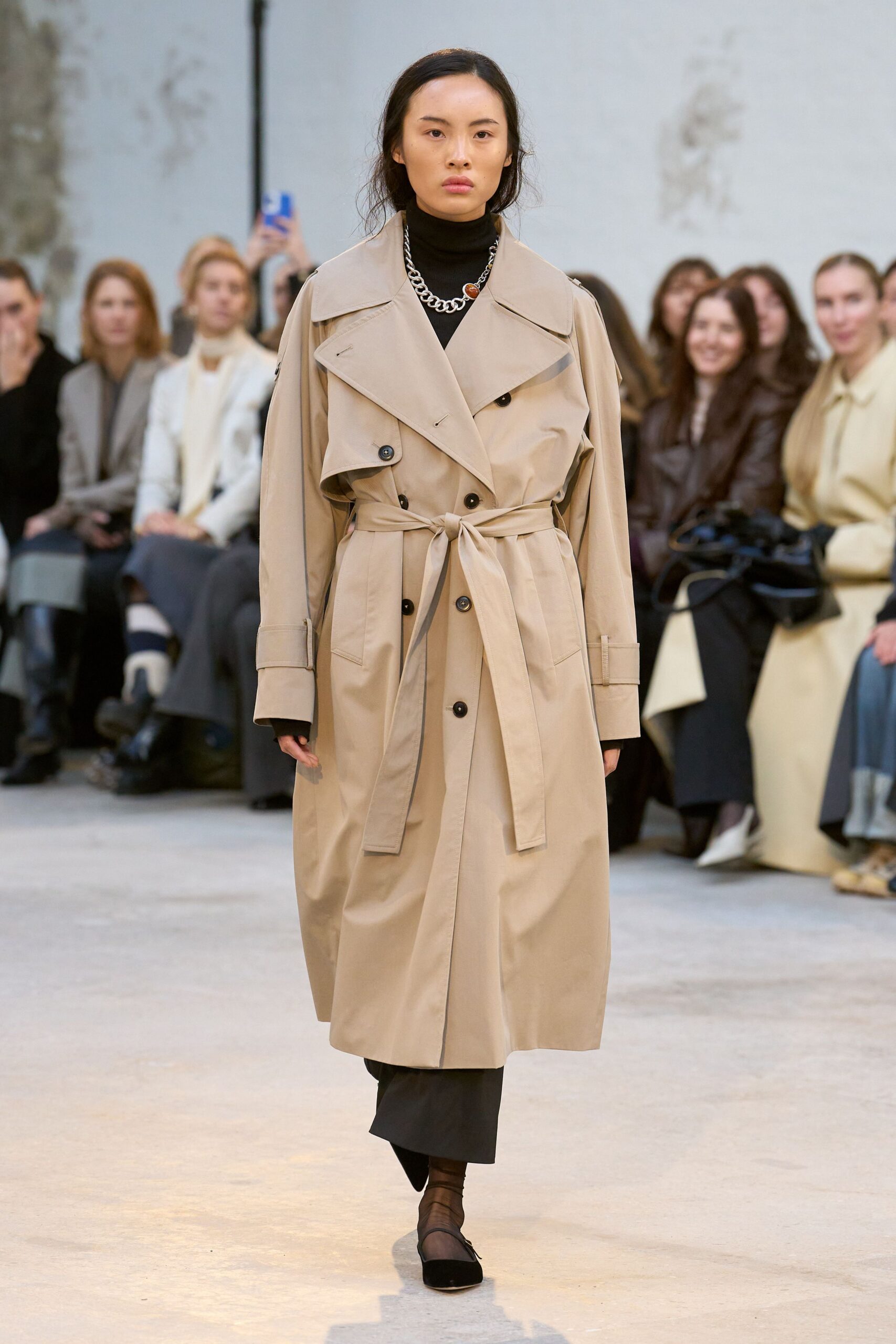 beige trench coat with black top