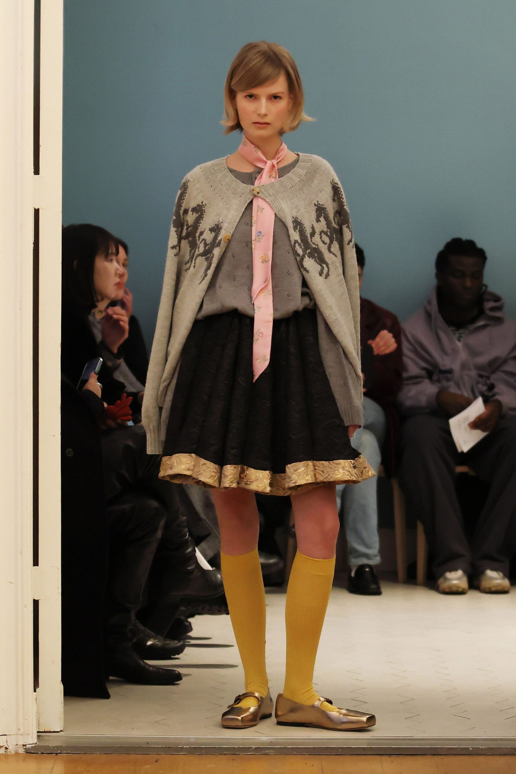gray embroidered sweater with black skirt