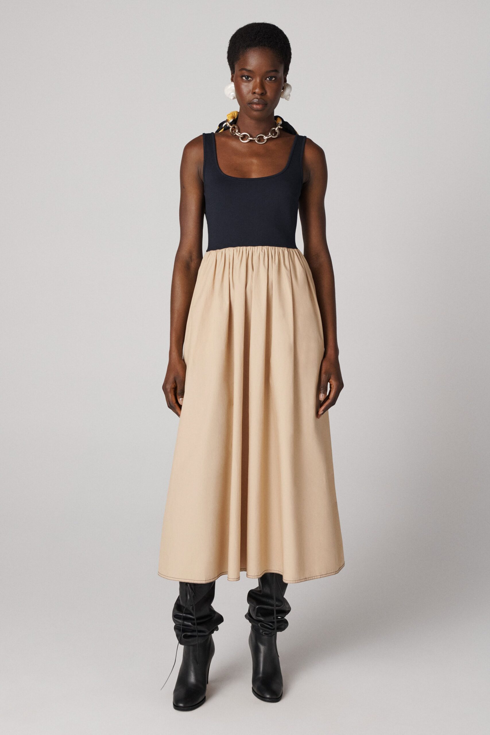 navy and beige pleated maxi dress with black boots