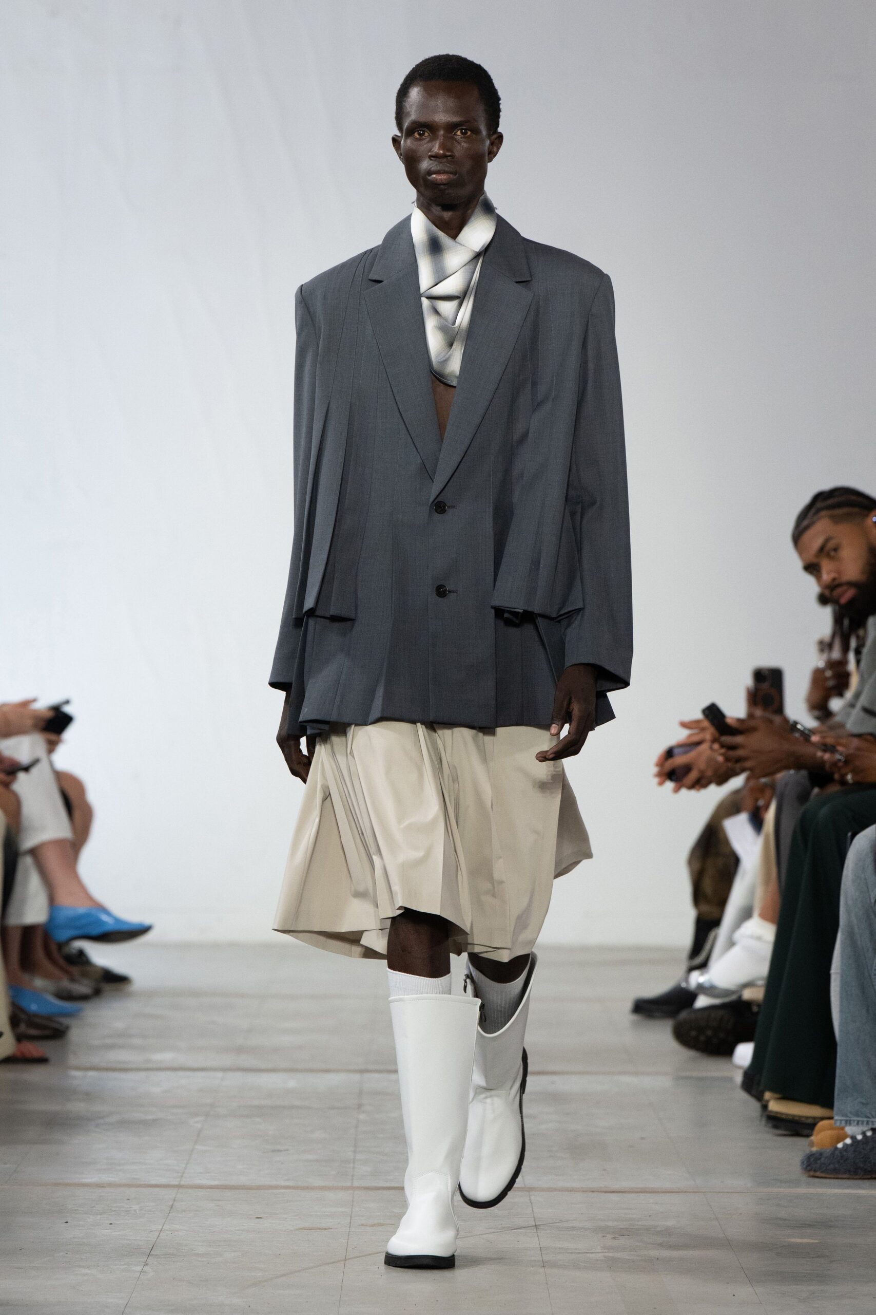 oversized gray blazer with pleated beige skirt