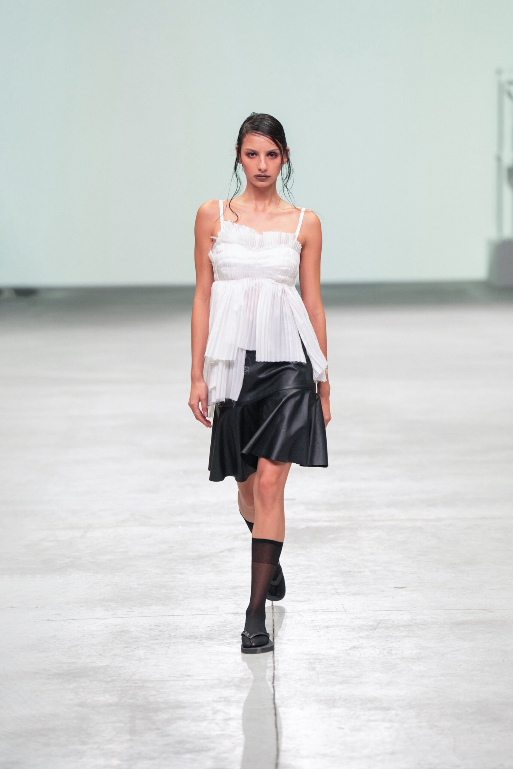 white pleated top black leather skirt