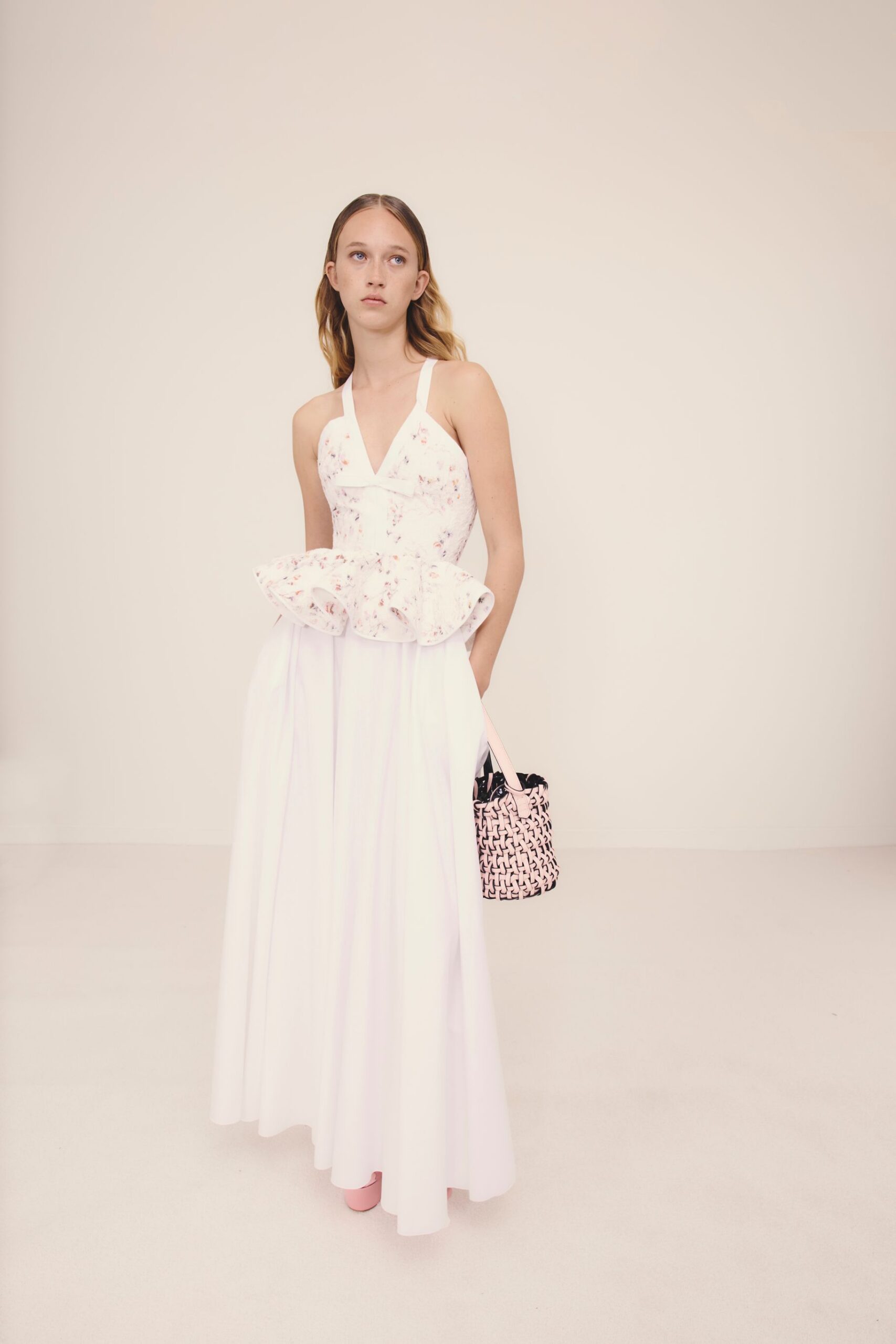 white cotton sleeveless v-neck fitted pleated flared gown