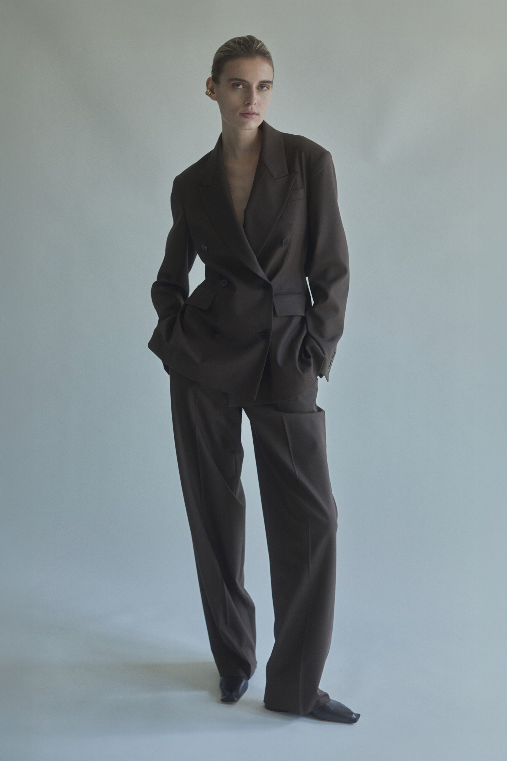 brown tailored suit with black shoes